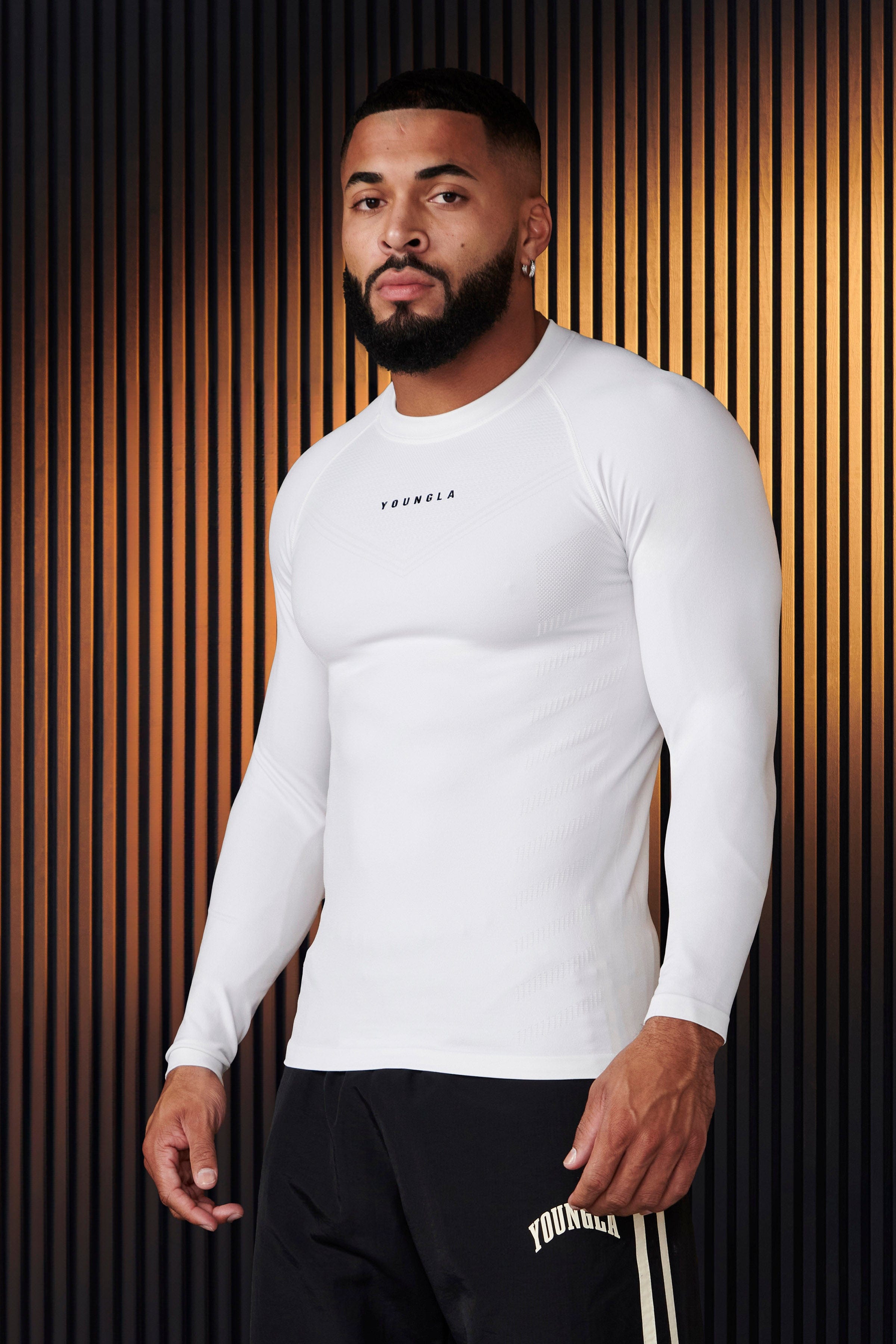 Mens compression shirt showcasing moisture-wicking technology during workout.