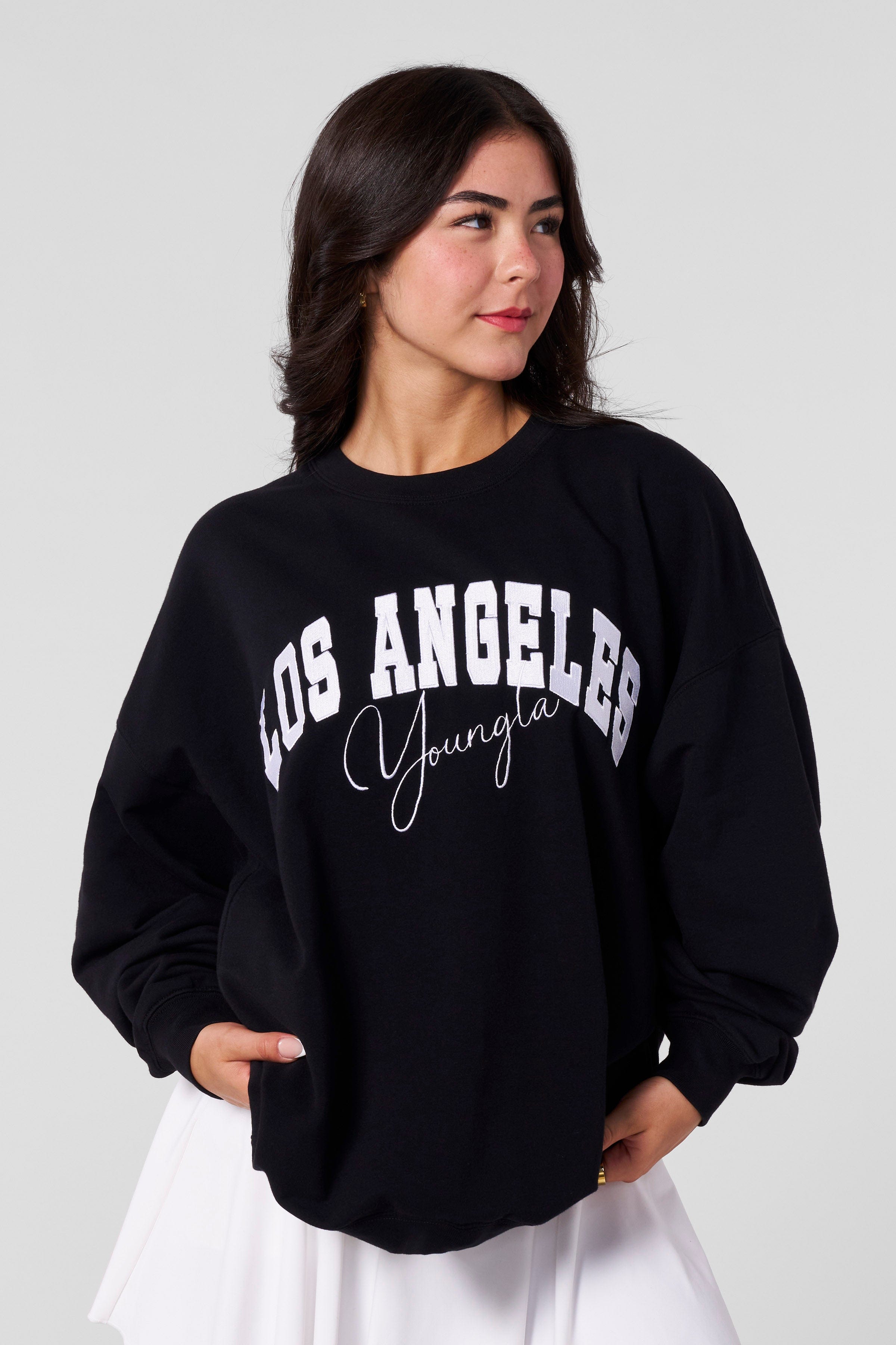 Back view showing the crewneck’s drape on a petite frame