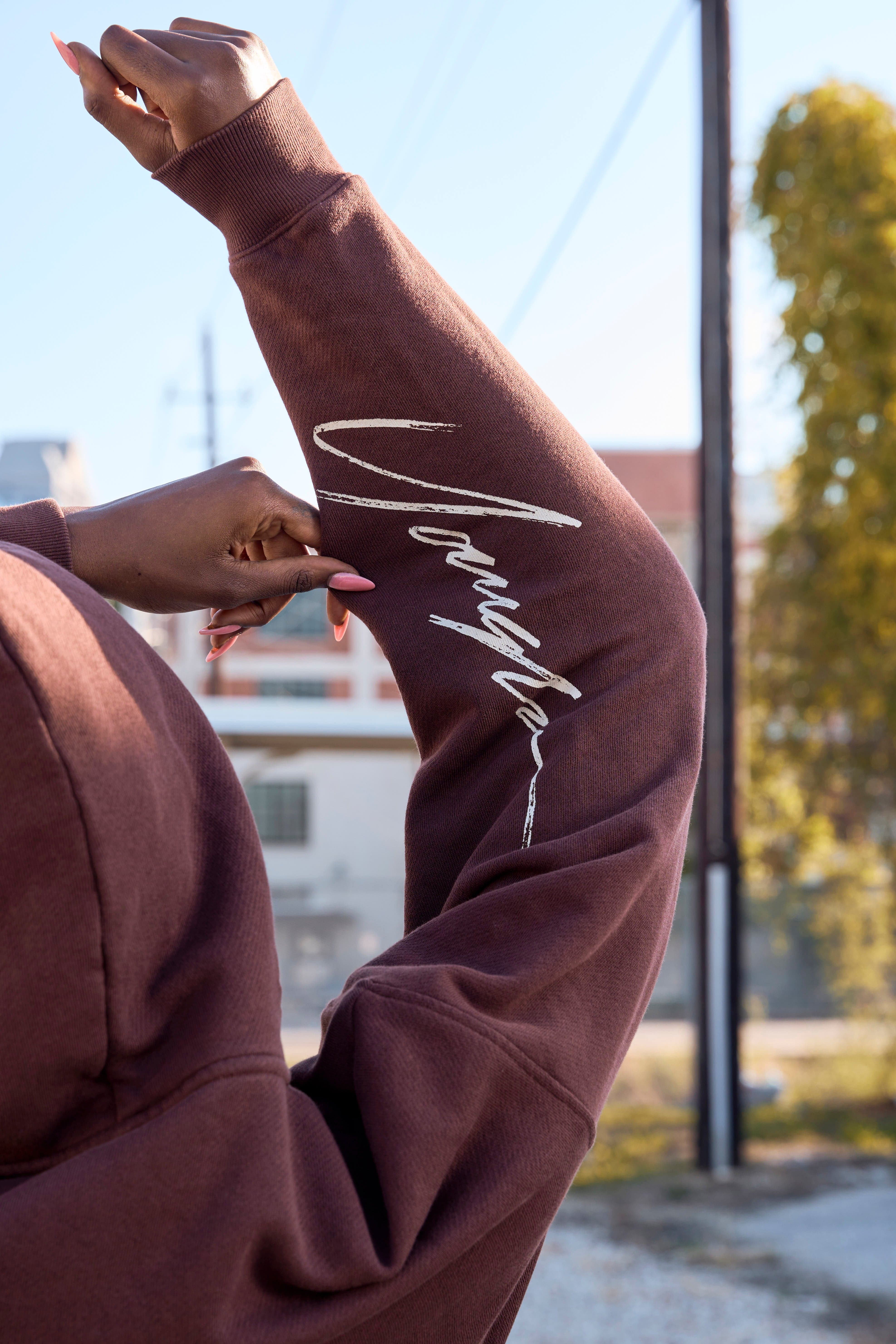 Model showcasing the relaxed fit of the black zip up hoodie.