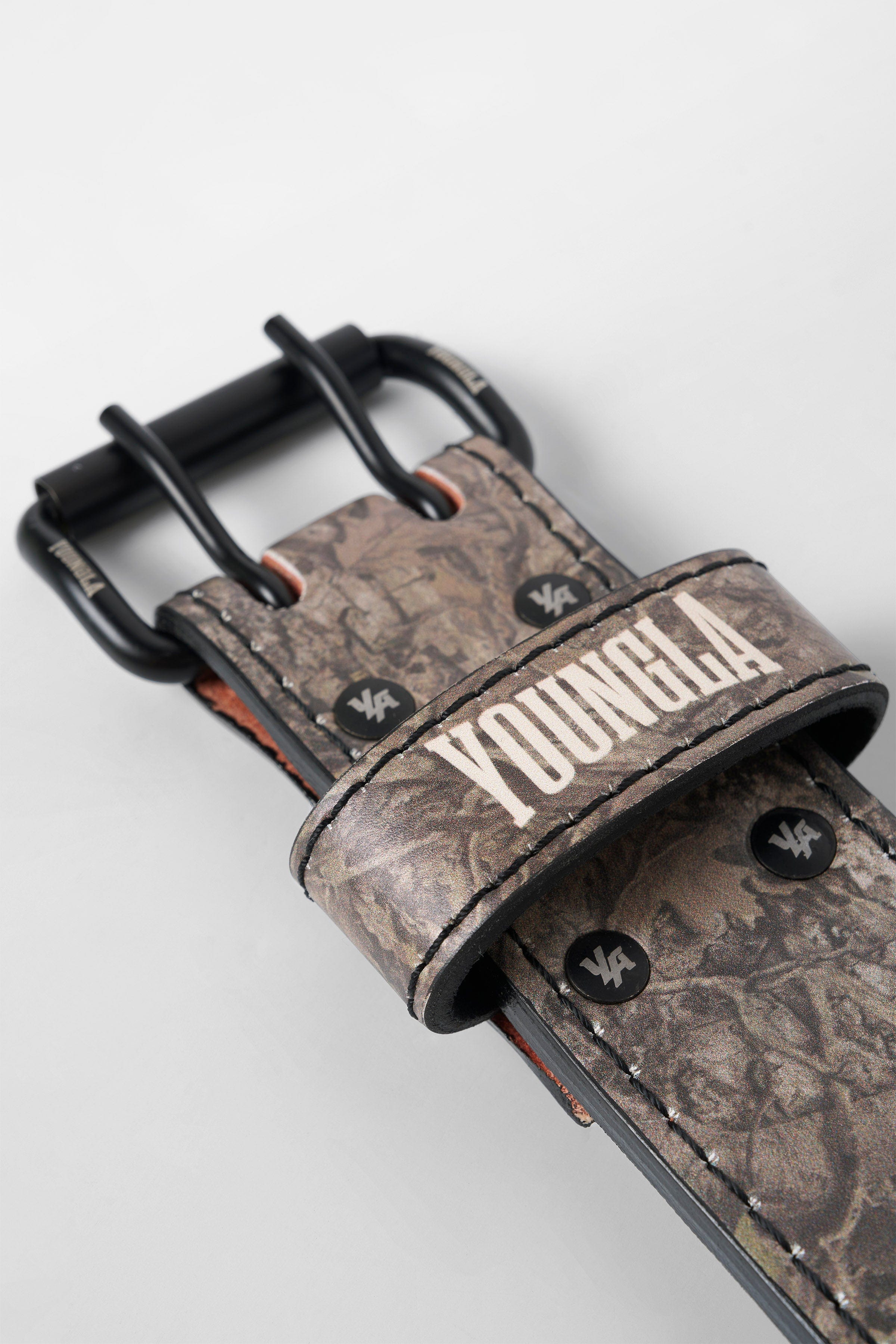Tree camo leather lifting belt worn during a powerlifting session for maximum support.