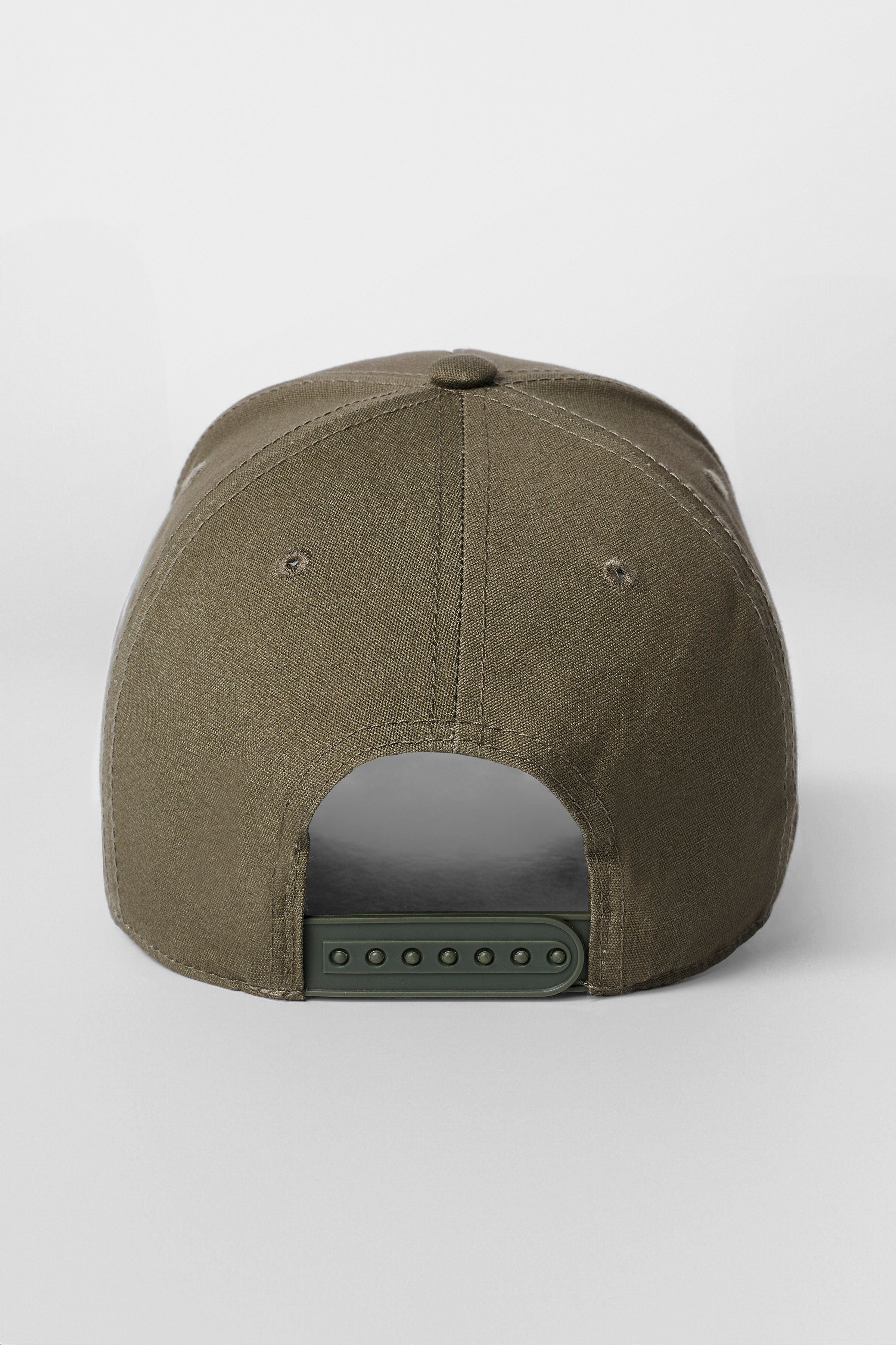 Close-up of embroidered logo on cotton hat with piping accents