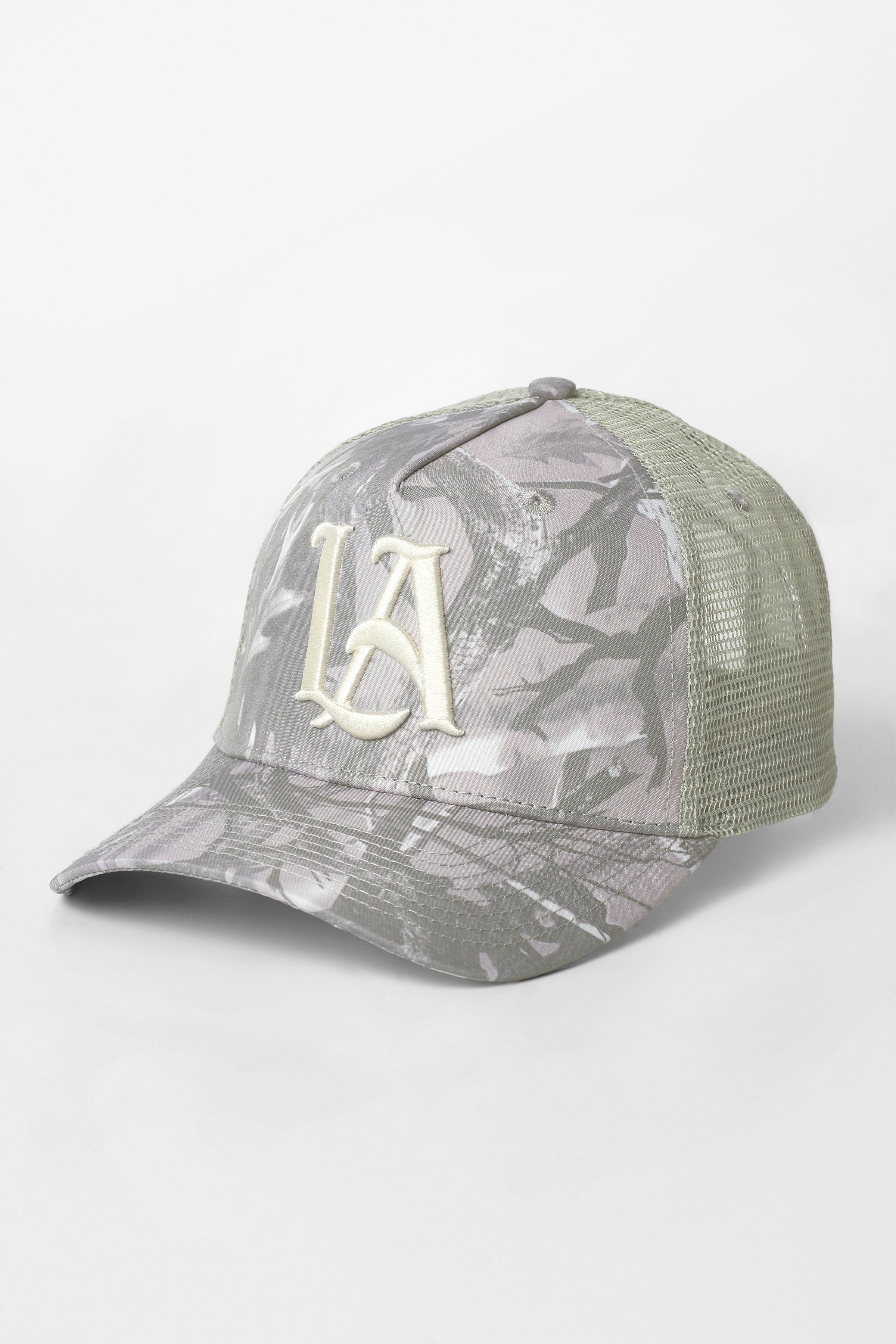 Front angle of camo trucker hat showing LA embroidery and tree camouflage