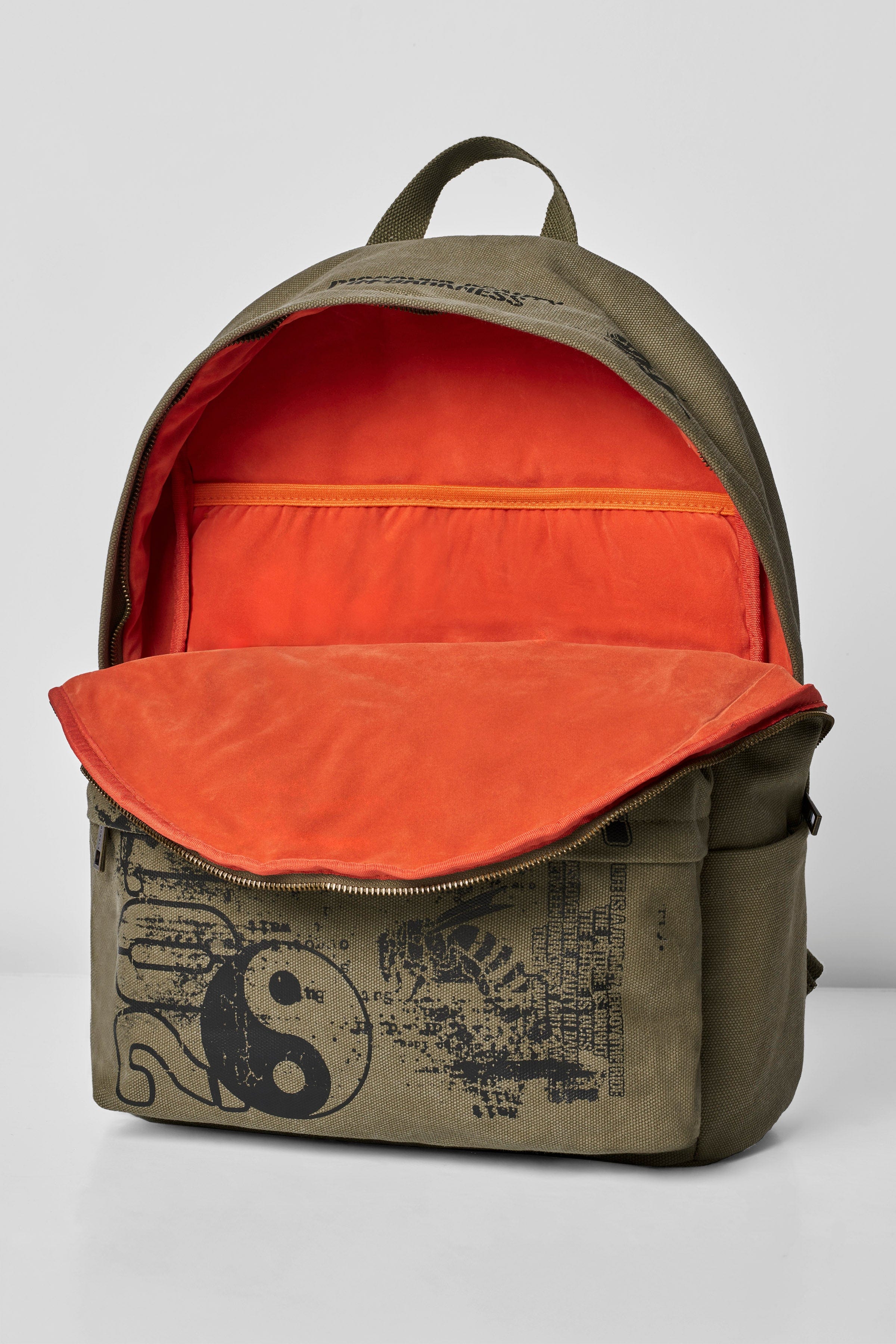 Detail shot of the durable canvas material and stylish ammo print on the backpack.