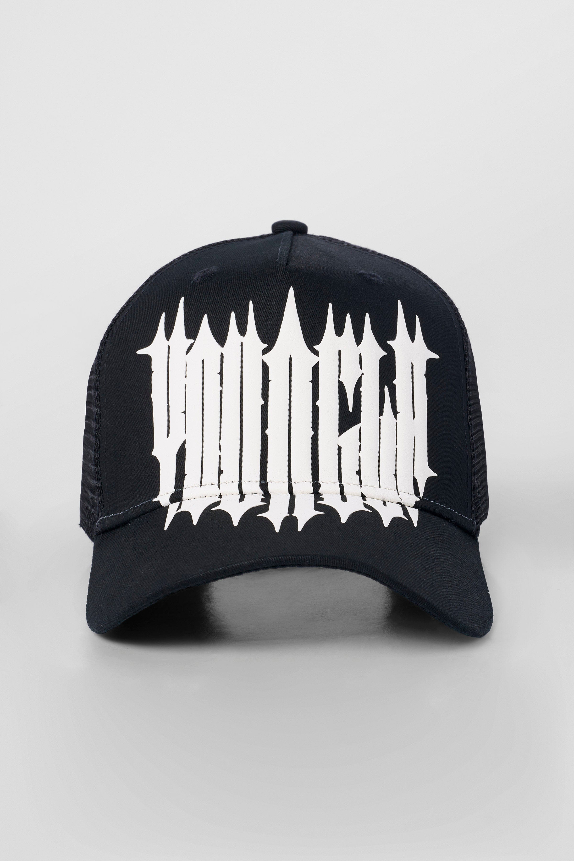 Side view of logo hats styled with denim jacket in urban setting