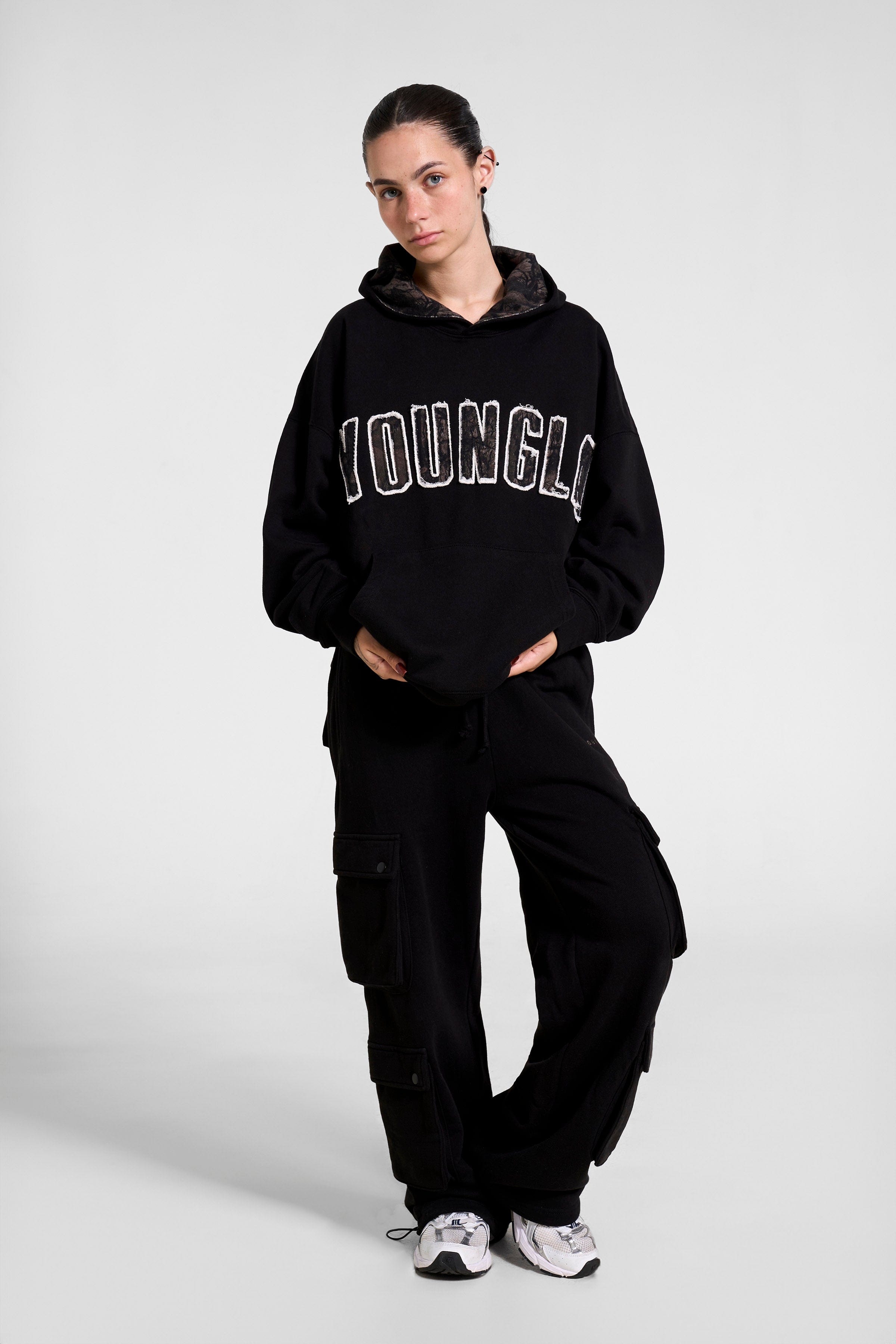 Close-up of the collegiate logo on the oversized hoodie.