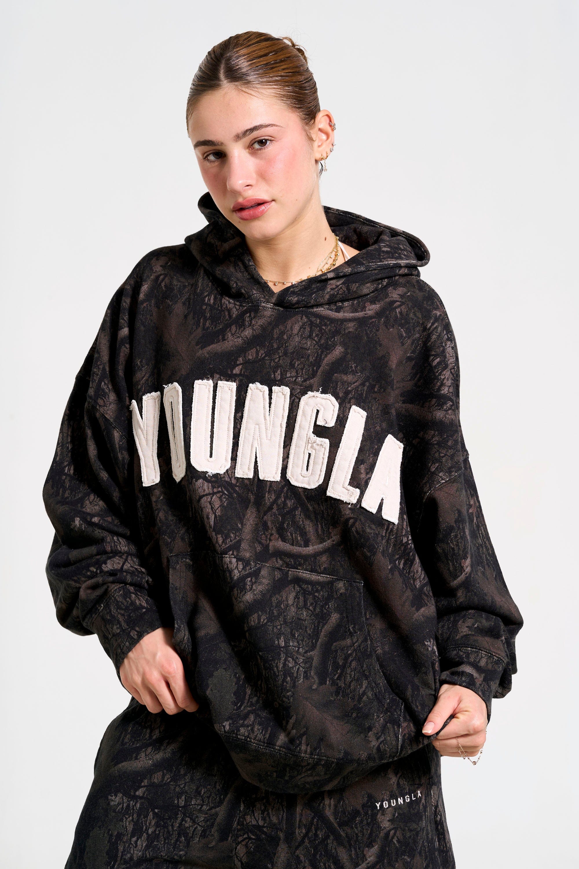 Front view of the oversized hunting hoodie in a natural setting.