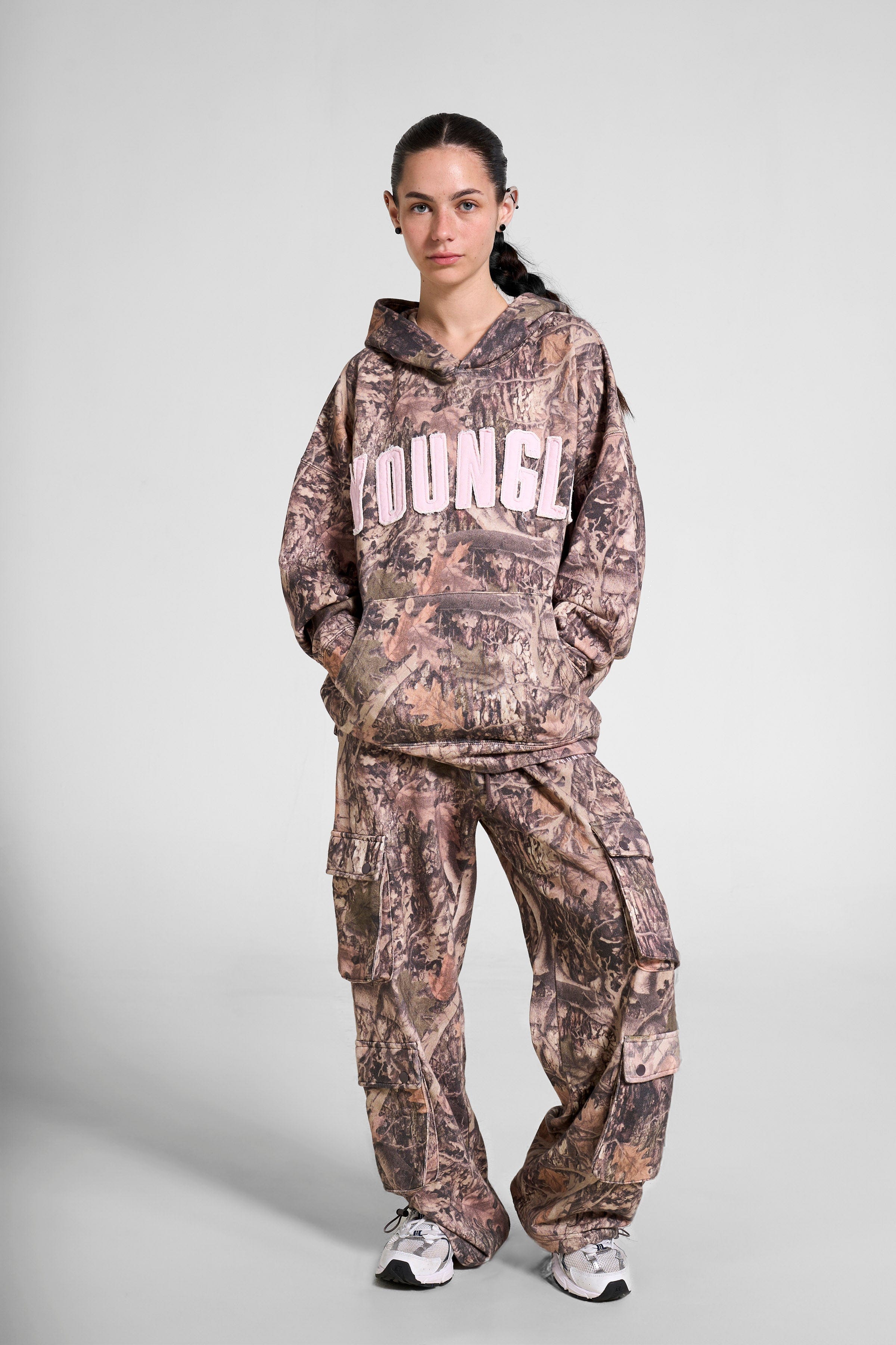 Front view of the oversized hunting hoodie in a natural setting.