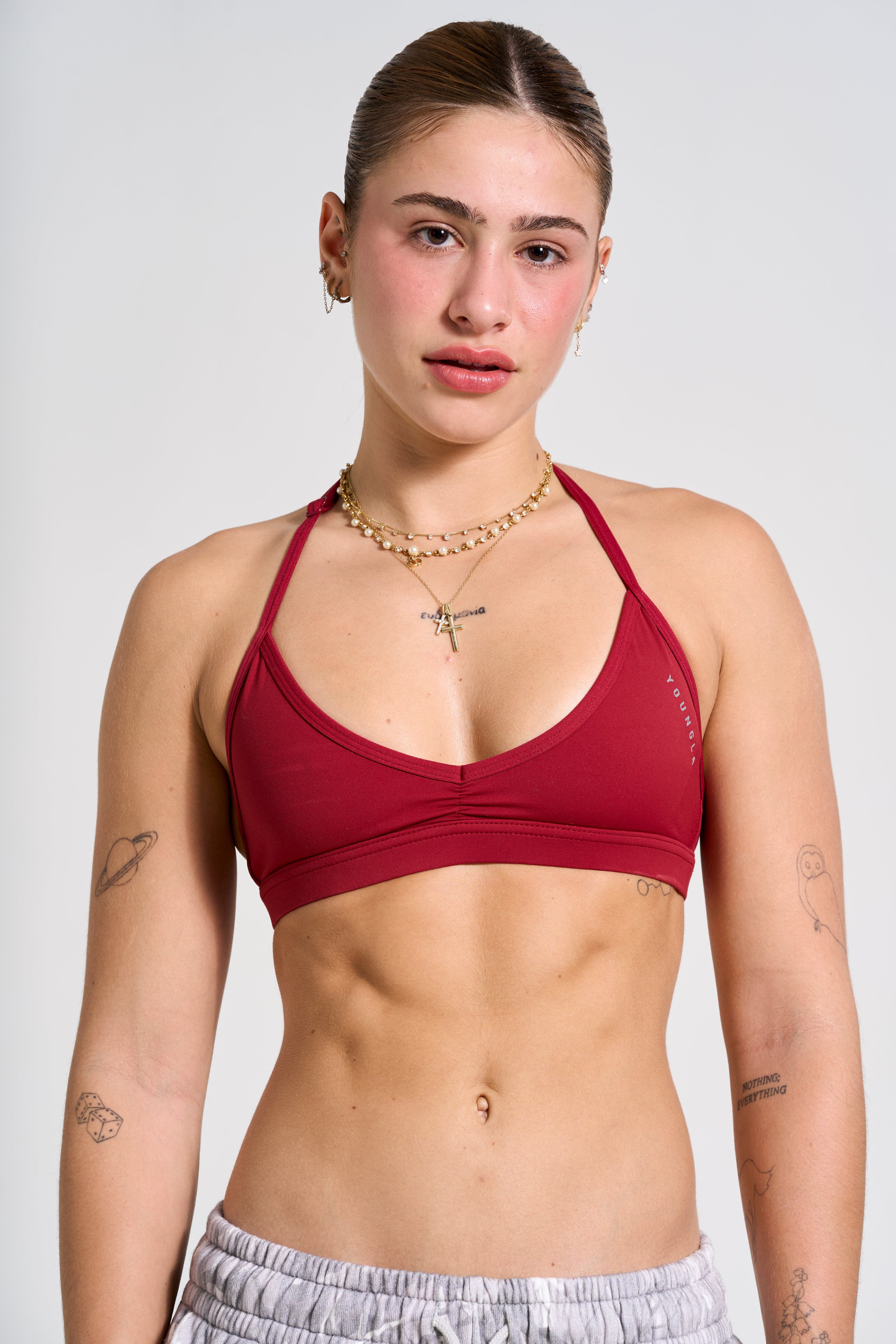 Model wearing the Urban V-Neck Yoga Sports Bra in a studio pose