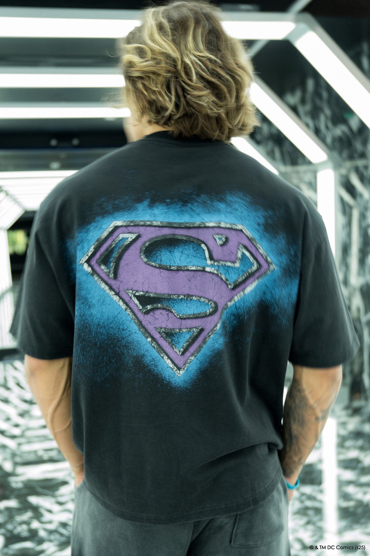 Model wearing the oversized Superman t-shirt in a casual setting.