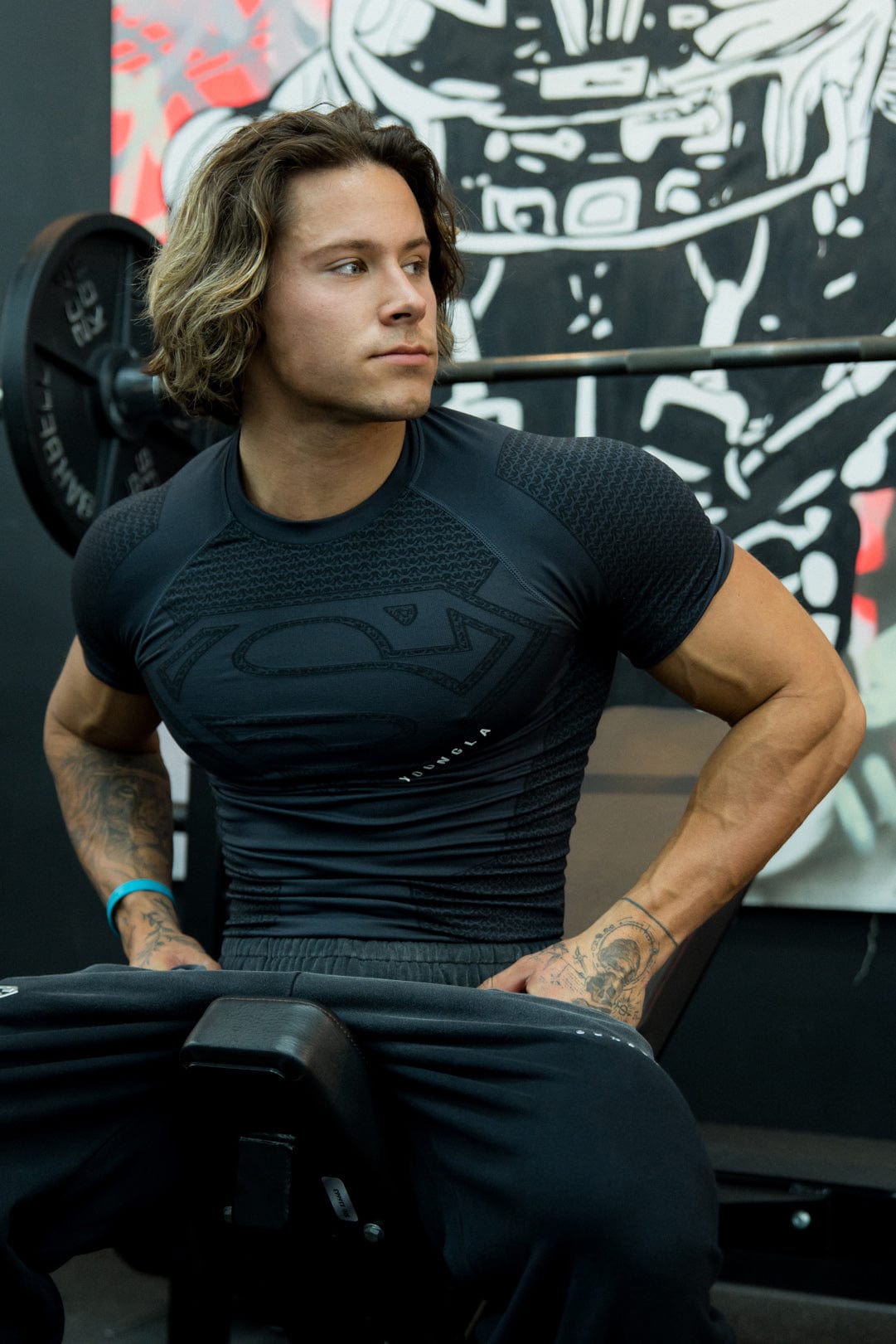 Athlete wearing the compression tee during a workout, highlighting flexibility.