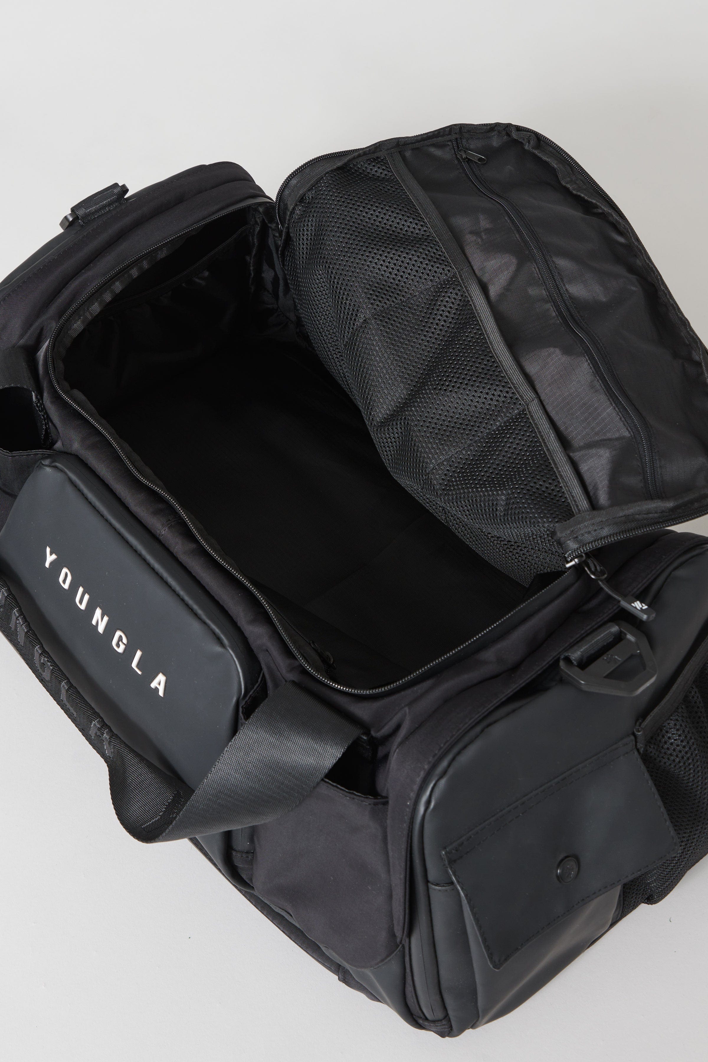 Side view of the backpack duffle bag highlighting the hidden straps and mesh padding.