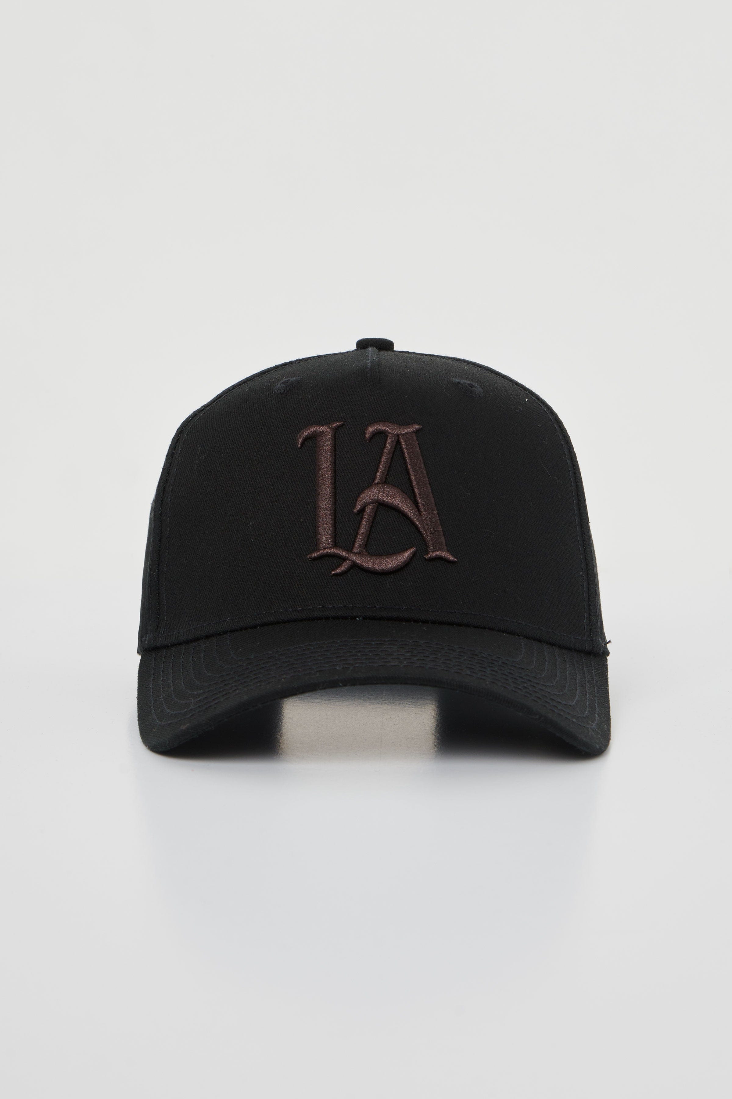 Side angle showing custom snapback hat fit and embroidery across twill fabric in earthy tones.