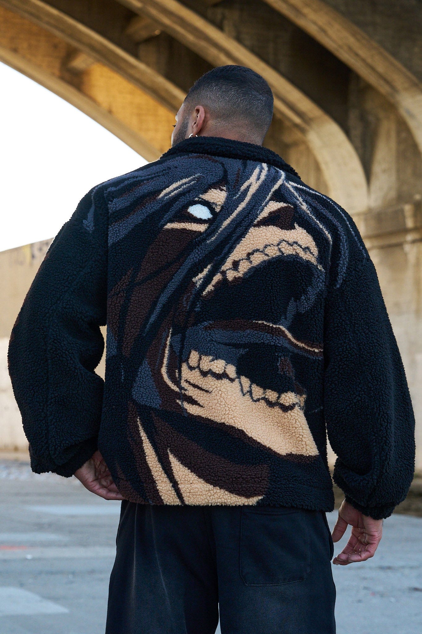 Front view of the zip-up sherpa jacket with a high collar, perfect for winter.