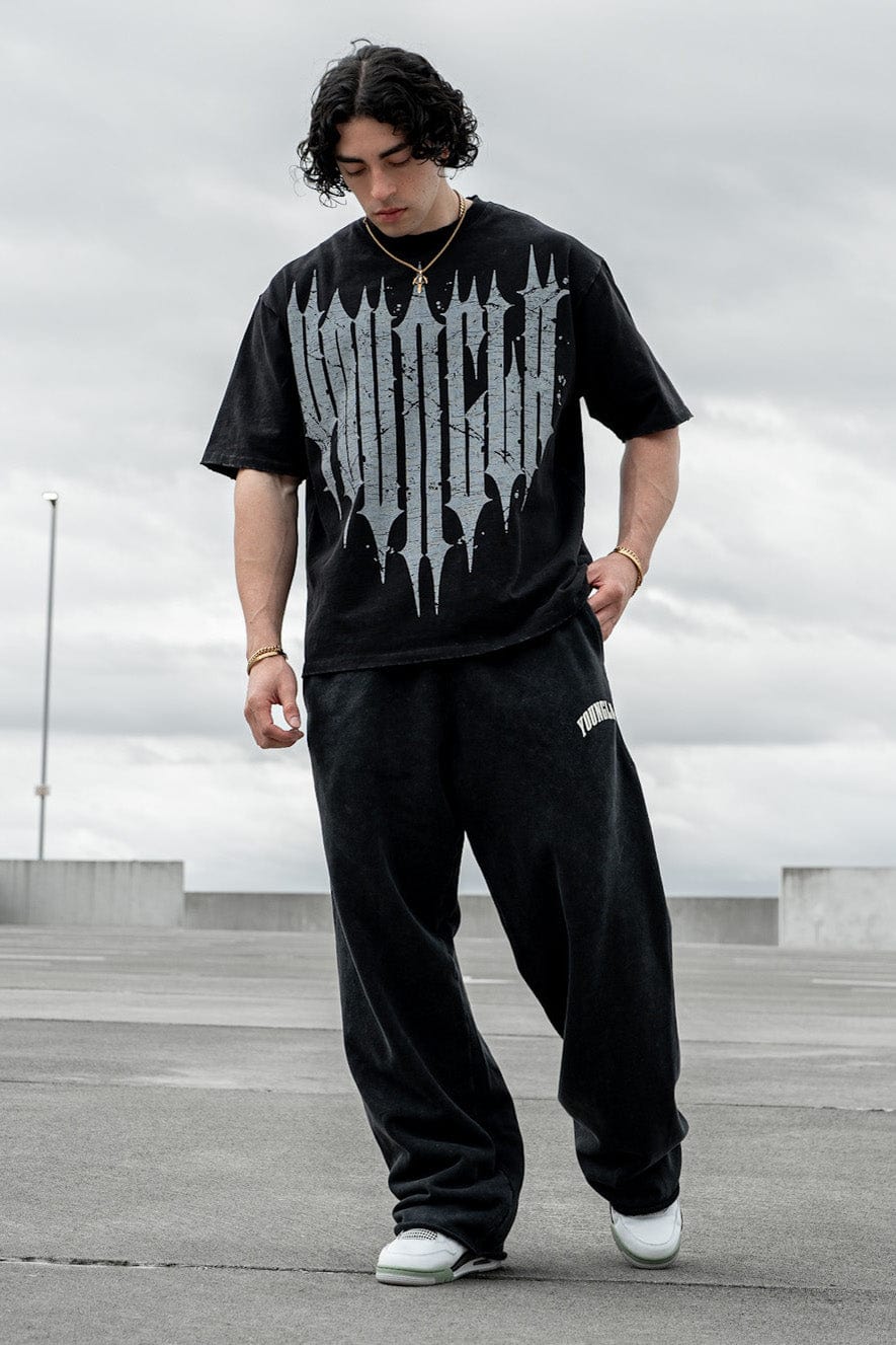 Front view of oversized graphic tee with distressed logo for streetwear clothing