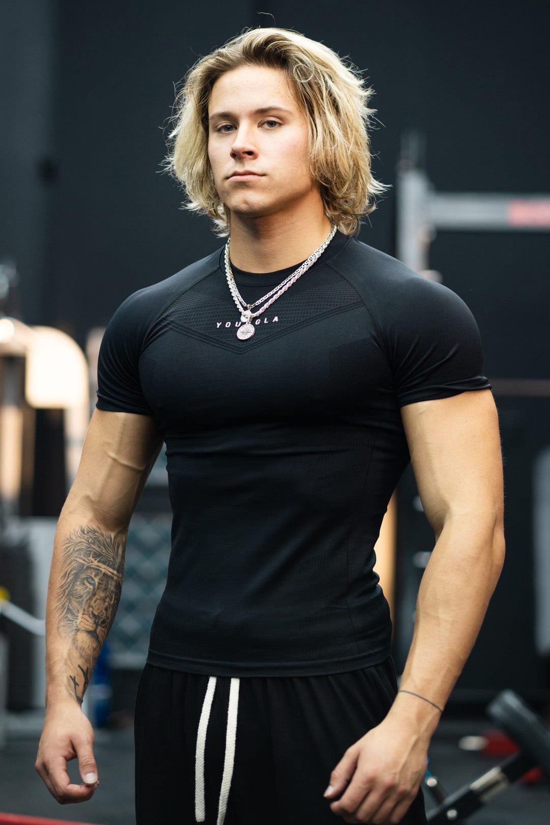 Front view of SuperVillain compression shirt on a man lifting weights.