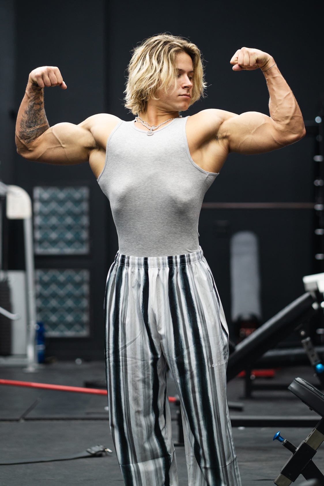 Side angle of compression shirts in oatmeal and heather grey on hanger