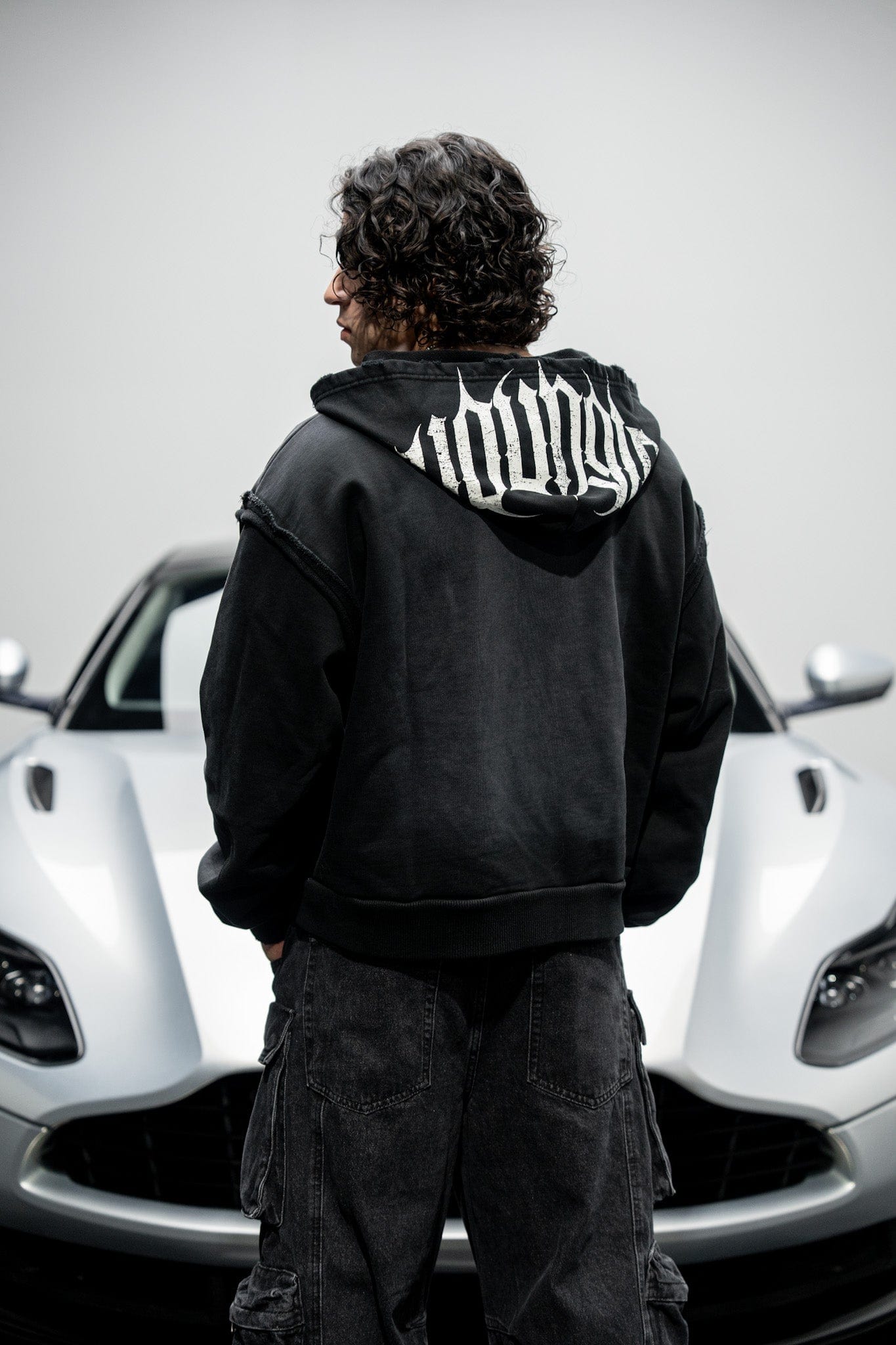 Model showcasing the boxy fit and short length of the deconstructed terry hoodie