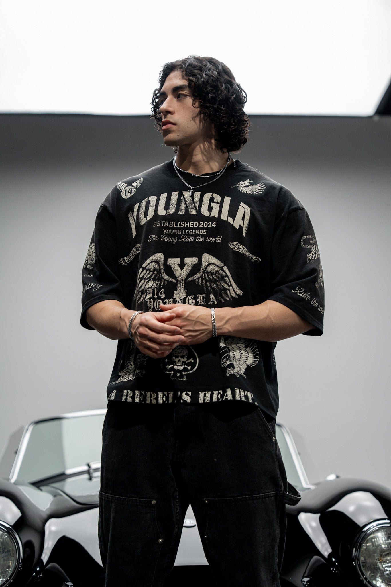 Model wearing the Rebel Vintage Graphic Tee in a casual outdoor setting.