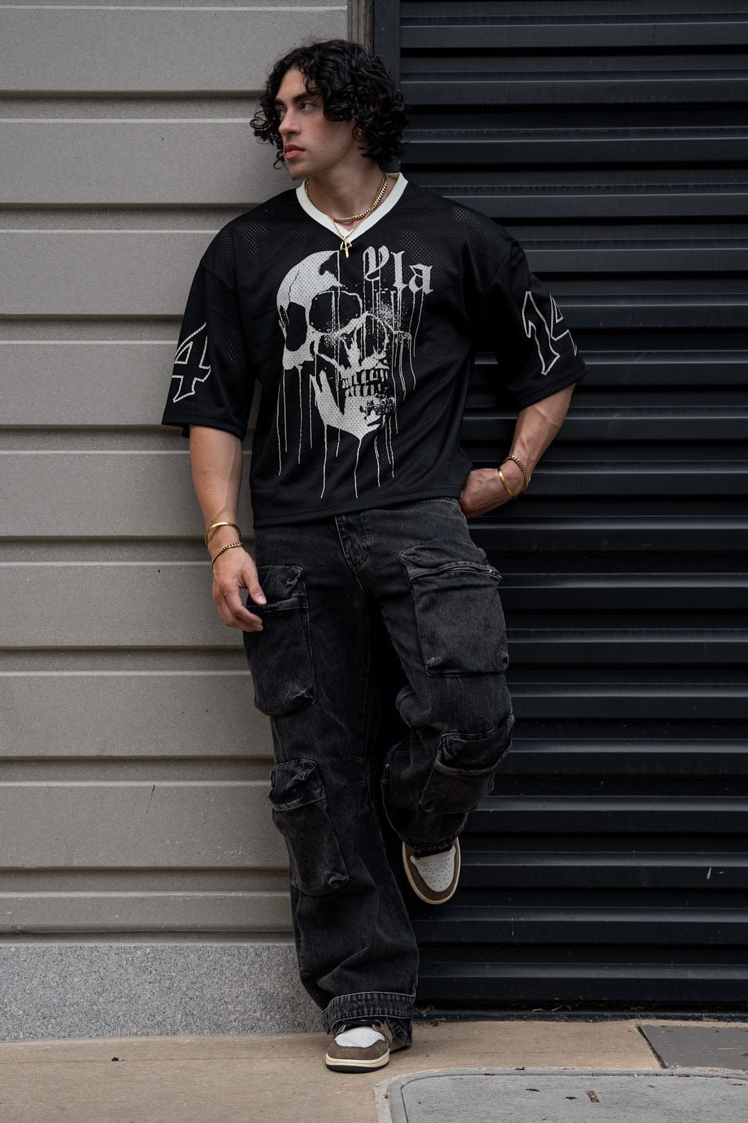 Model wearing the edgy football jersey during a casual outdoor game