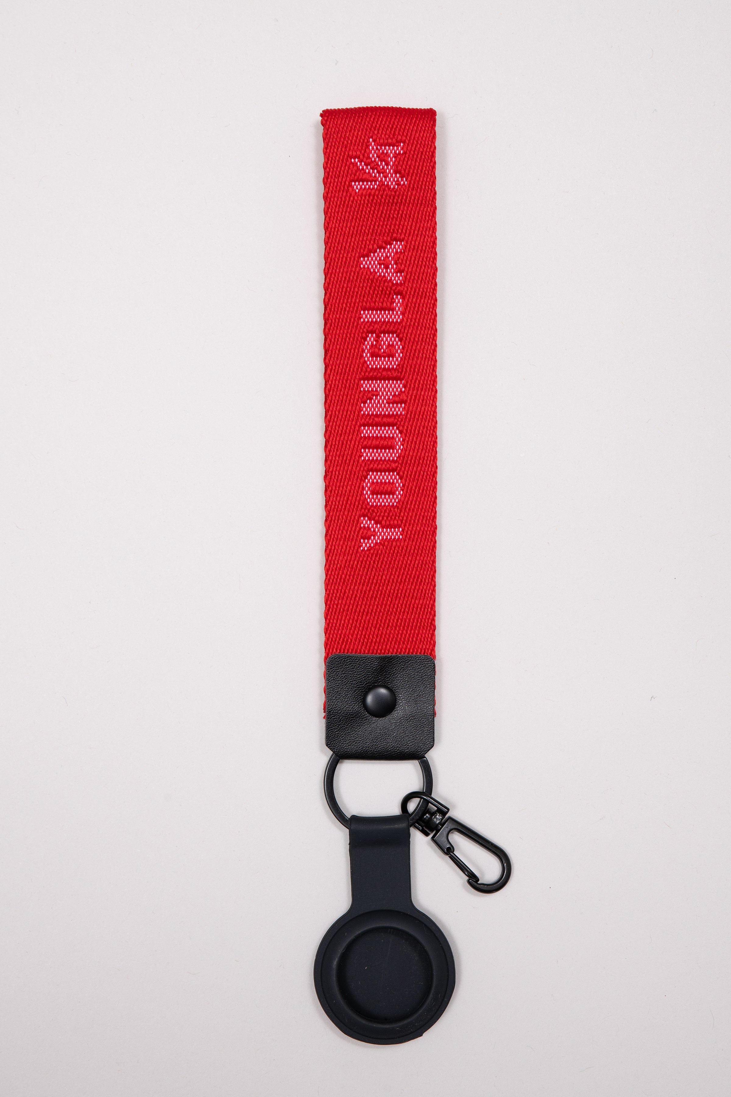 YoungLA stylish keychain clipped to a canvas backpack during London commute