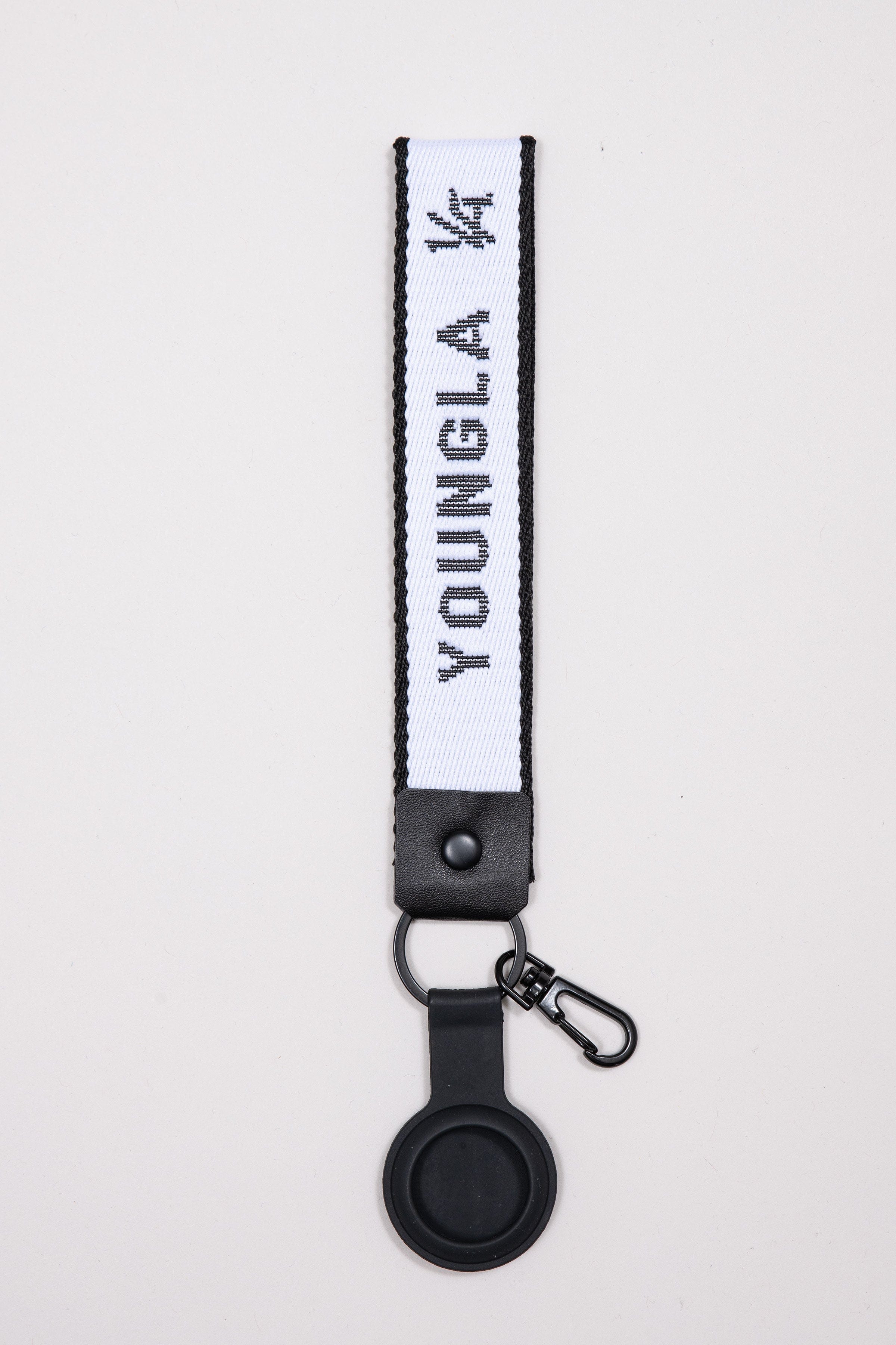 Assorted custom made keychains displayed on a wooden desk for gifting