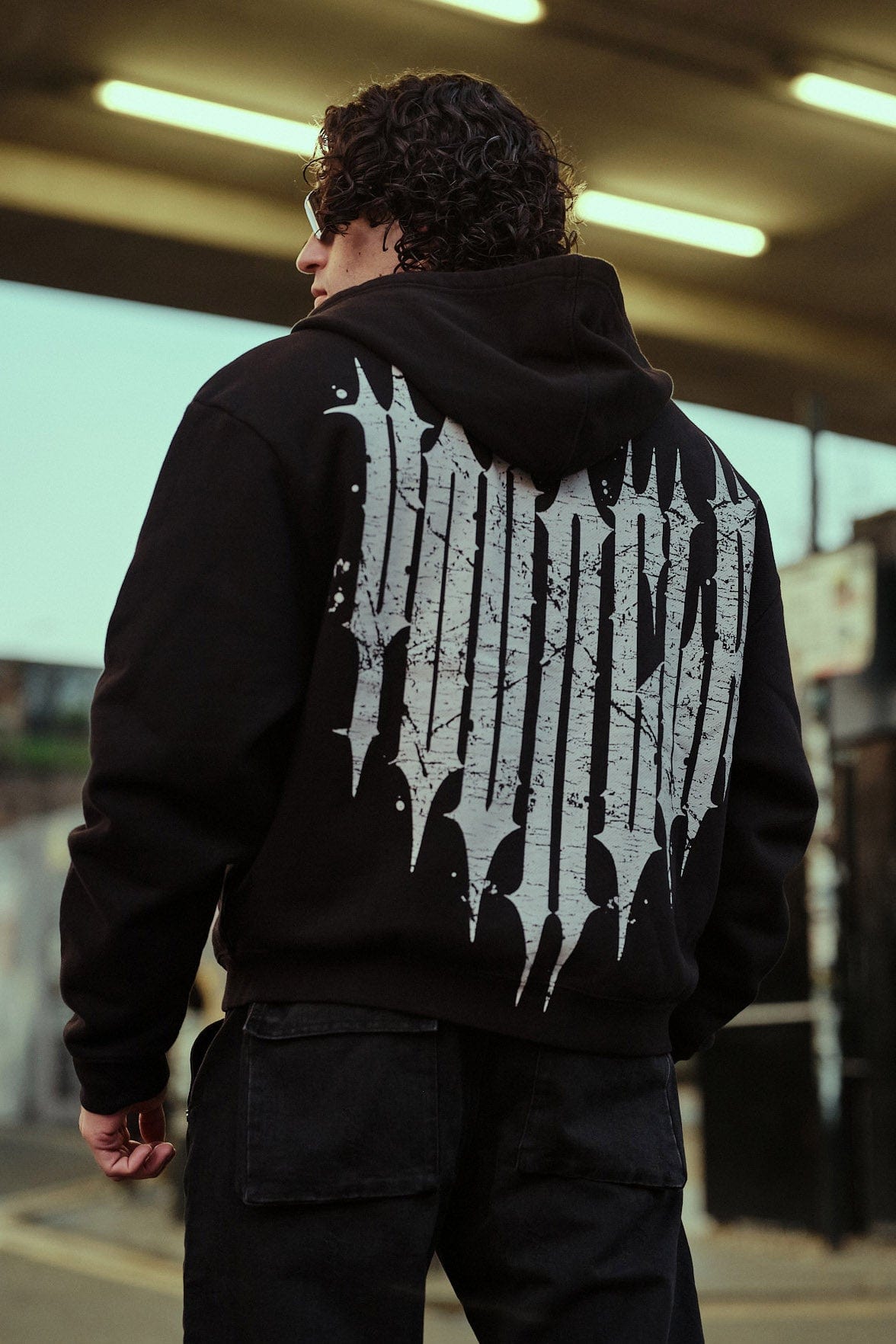 Front view of the Revenge zip-up hoodie highlighting the boxy fit and short length