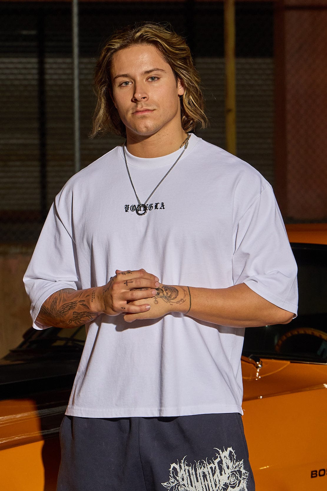 Back view of model showcasing the cropped length of the boxy fit shirt