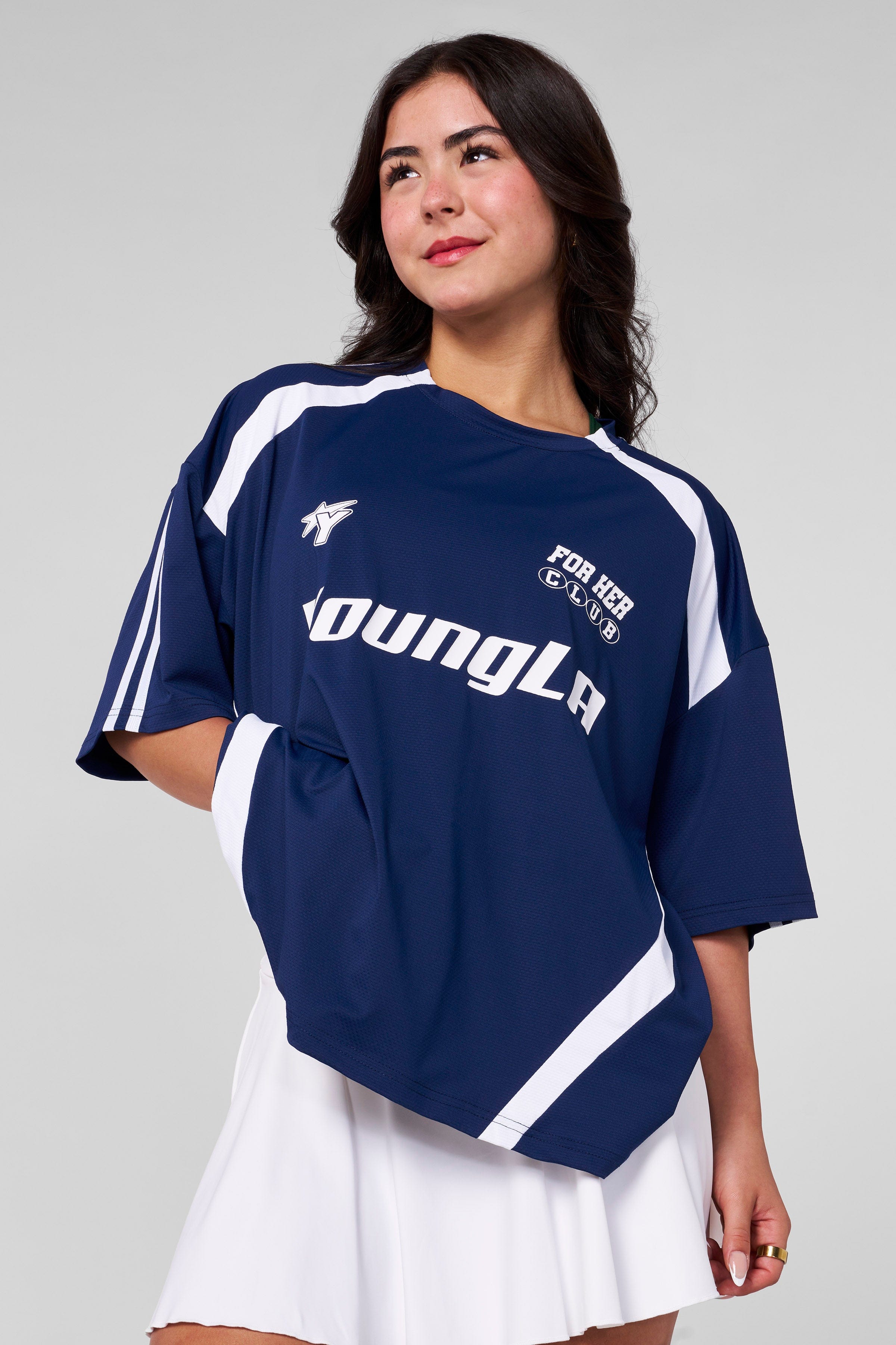 Model wearing oversized jersey outdoors near Georgia stadium