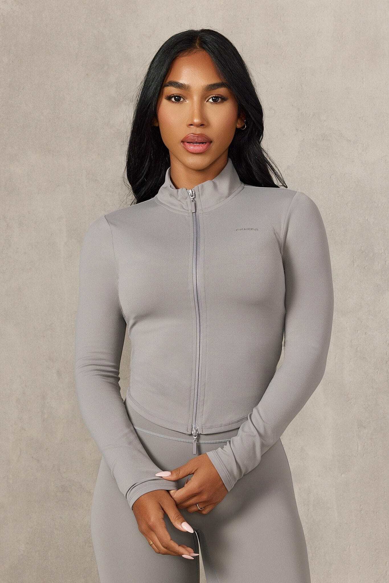 Front-facing view of gym jacket showing double zipper and contour fit