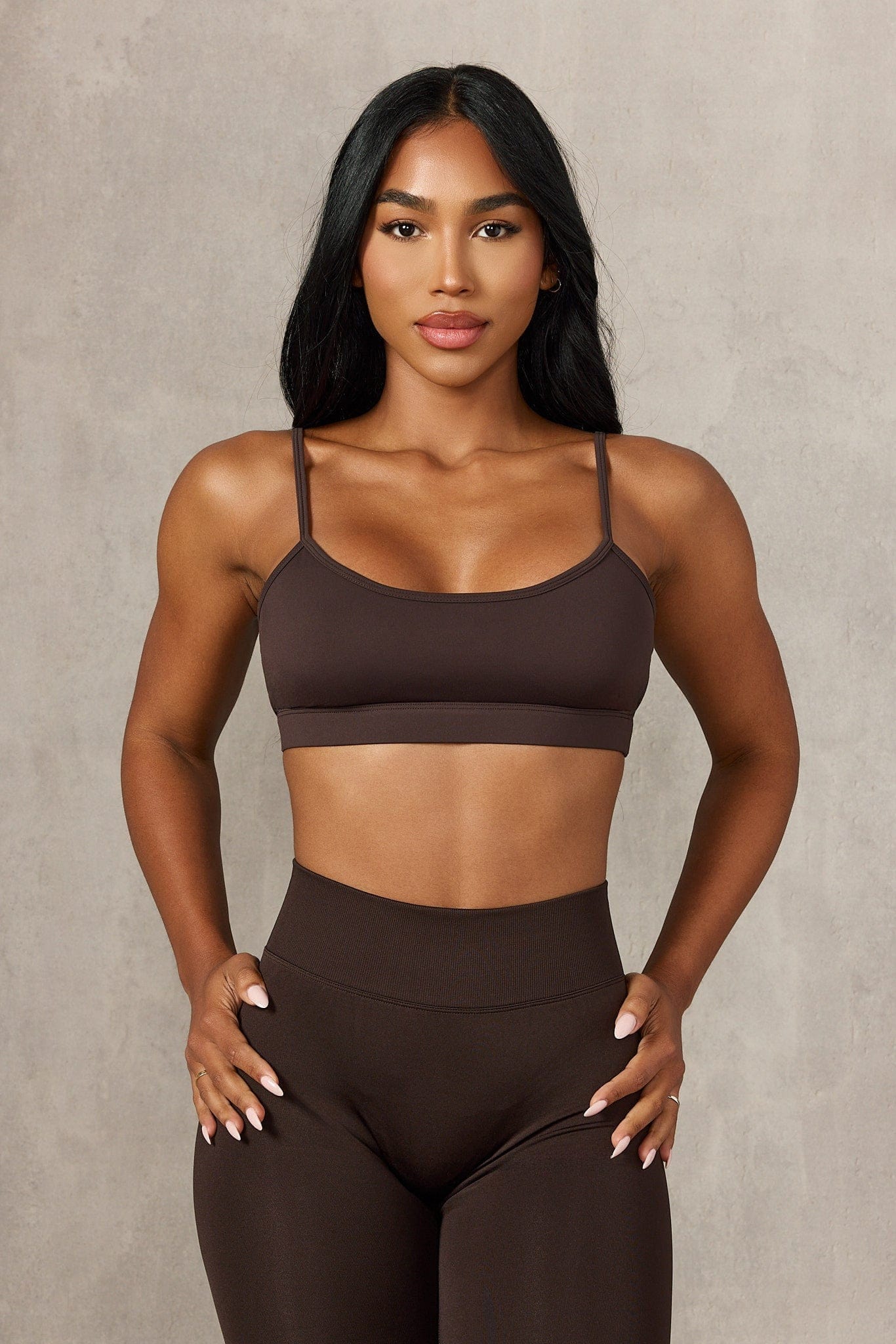 Woman stretching in the gym wearing the supportive workout bra for high-impact activities