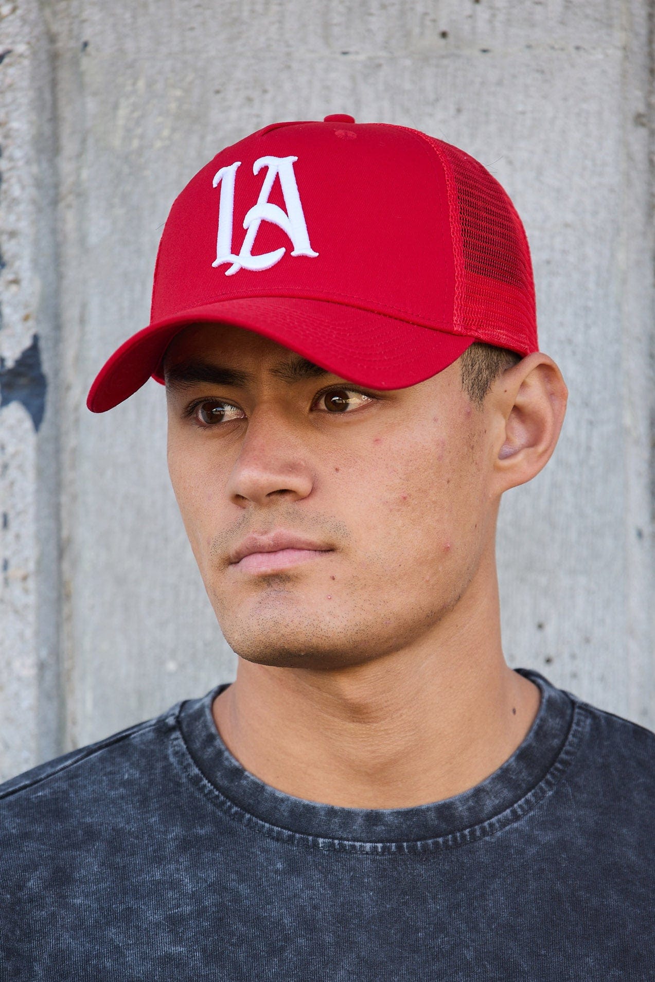 Close-up showing stitching details of a frame hat with signature design elements