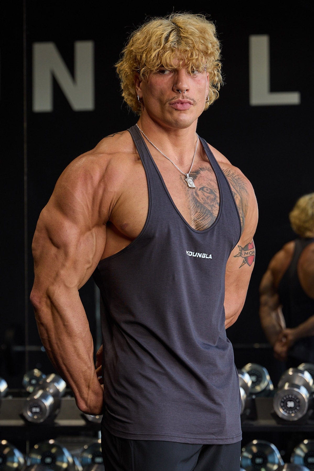 Back view highlighting the open design of the muscle tank top.