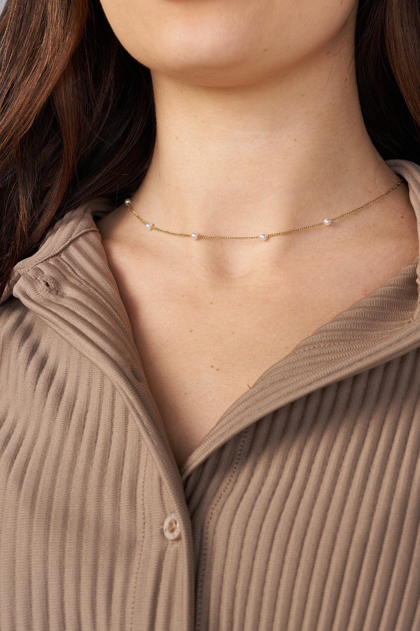 Close-up of the pleated details on the Aria top, perfect for formal outings.