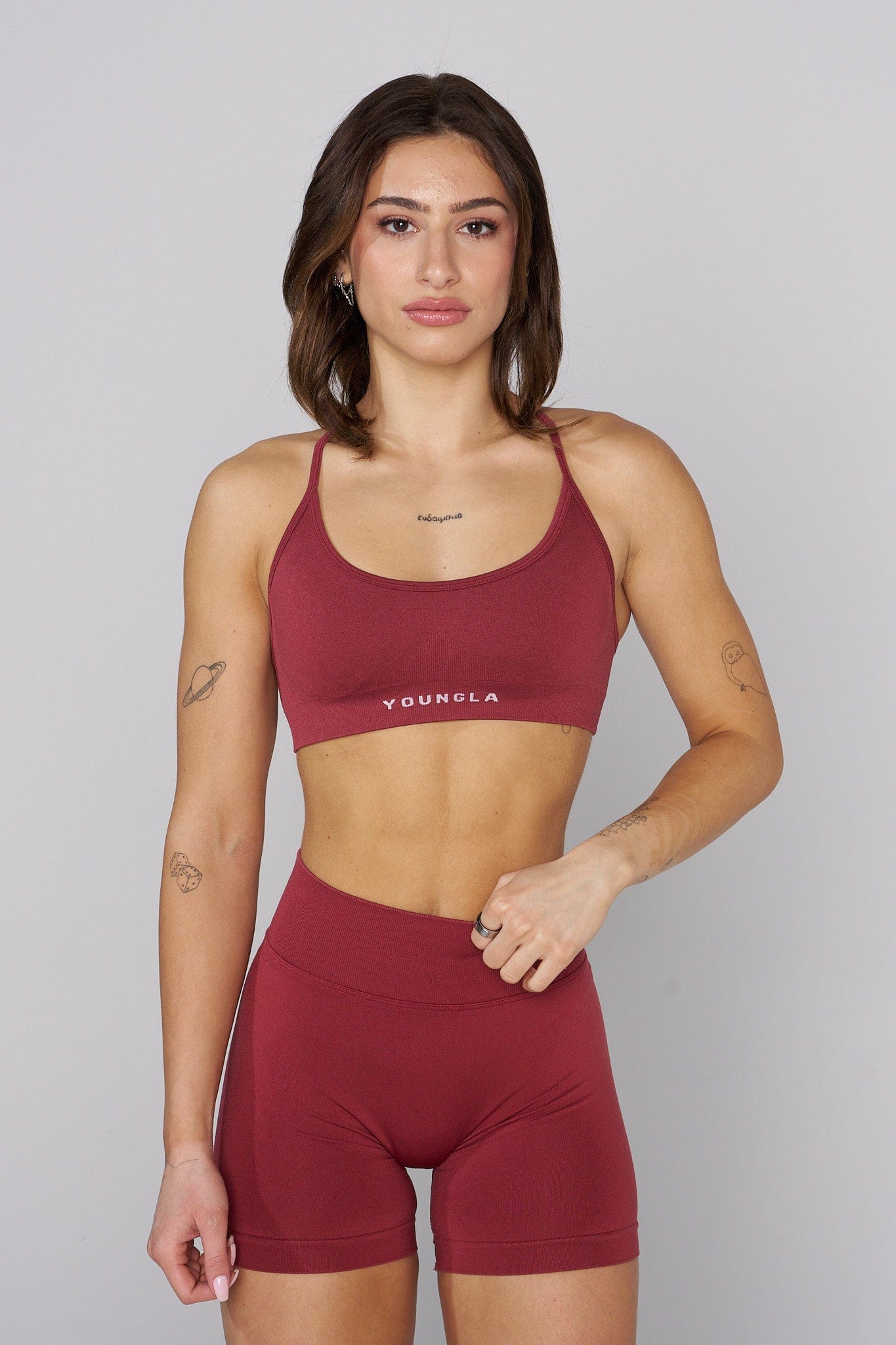 Model performing light stretch in cross back bra, showing support and flexibility
