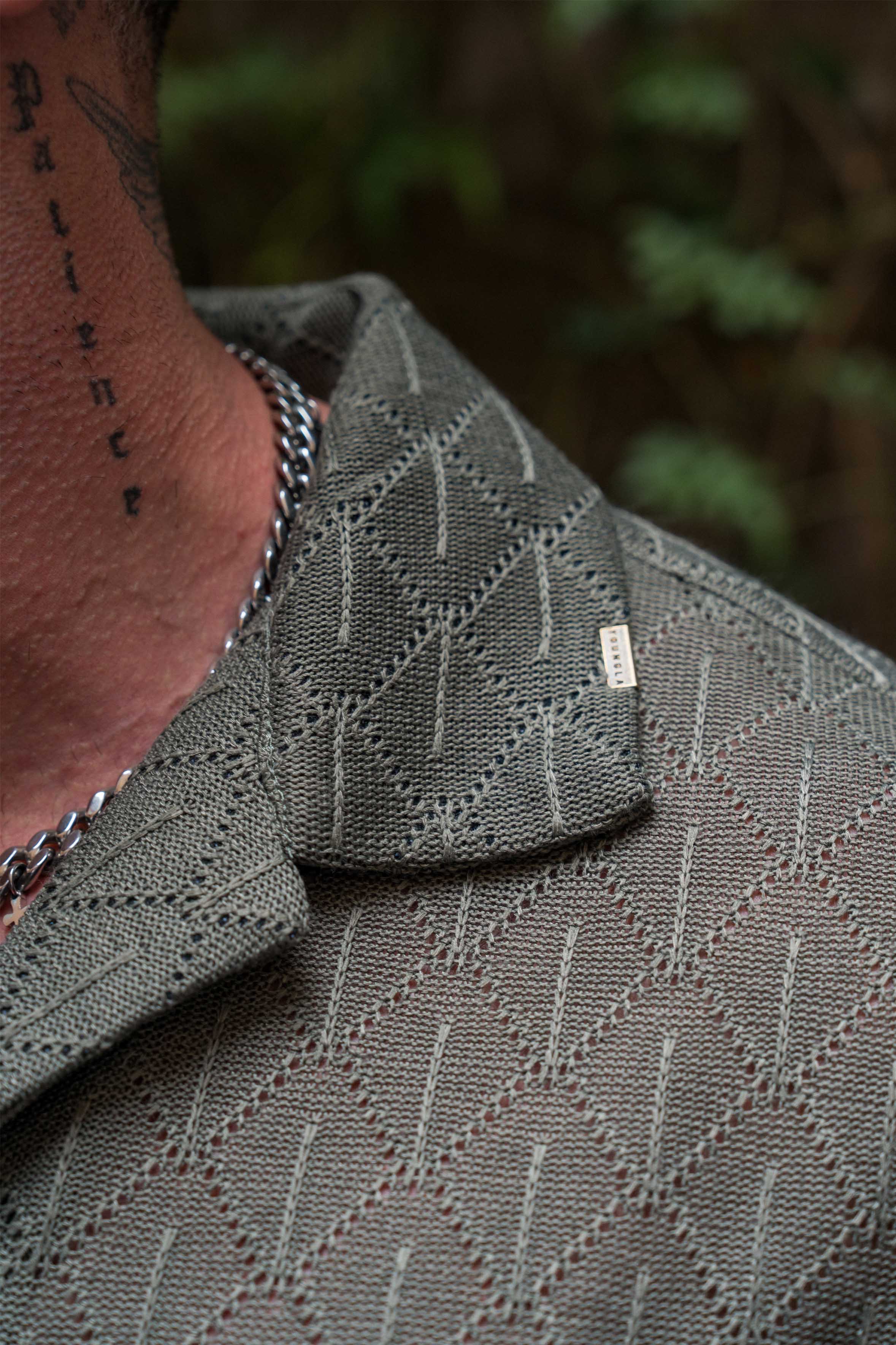 Model wearing the crochet button-up at a casual outdoor event.