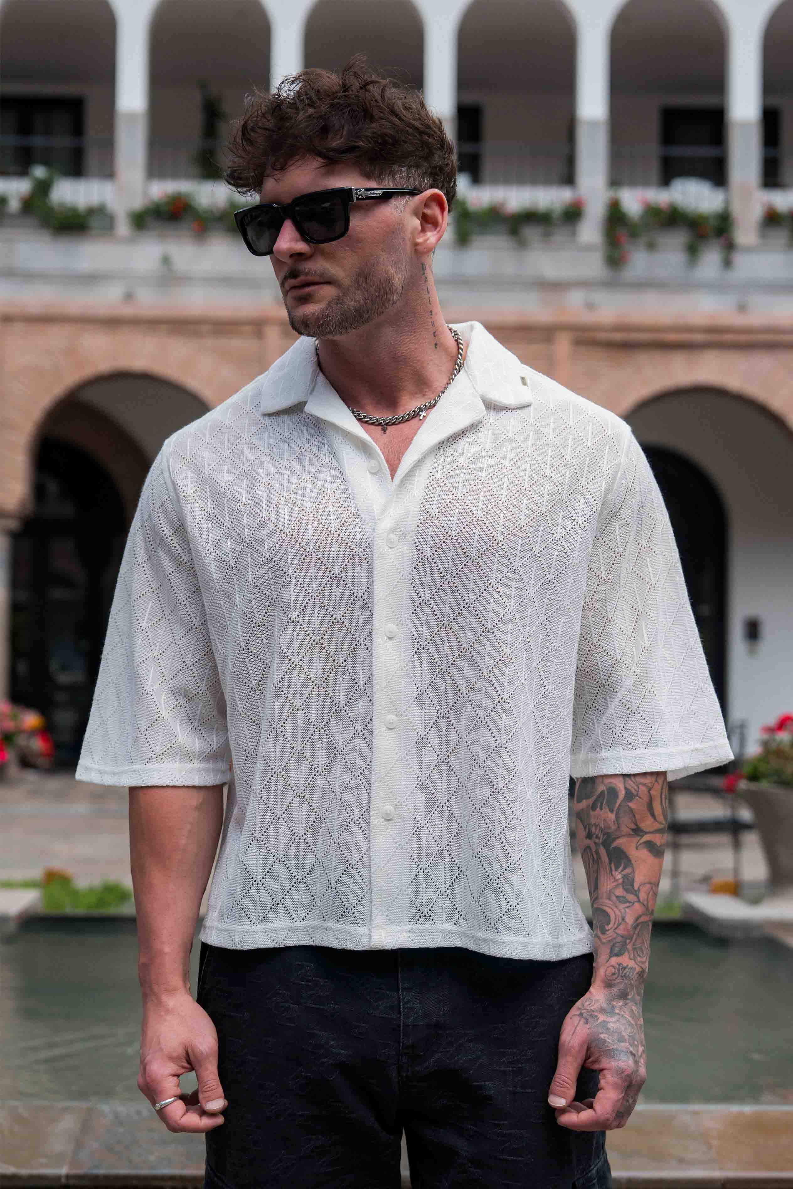 Front view of the crochet button-up shirt, ideal for summer parties.