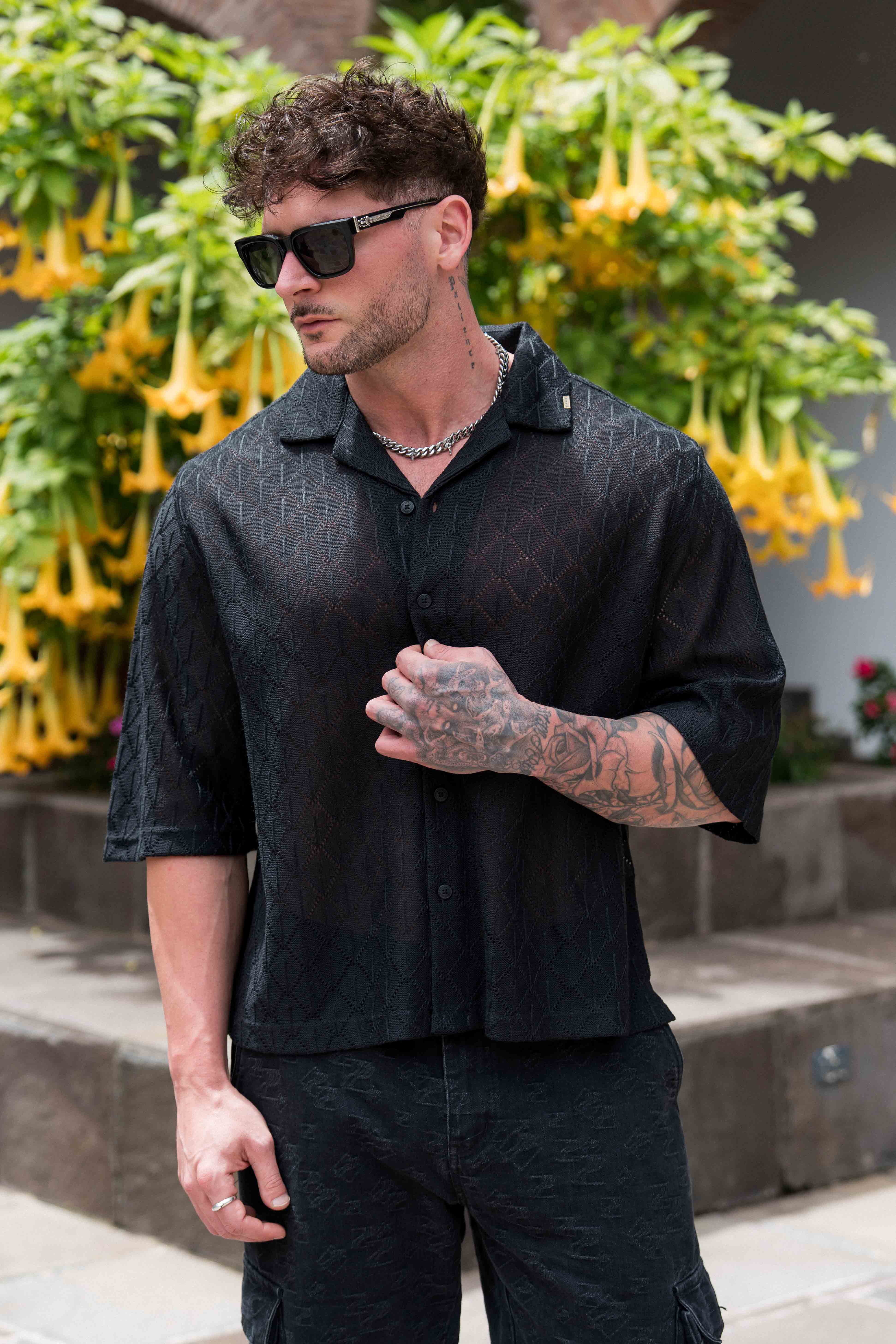 Model wearing the crochet button-up at a casual outdoor event.