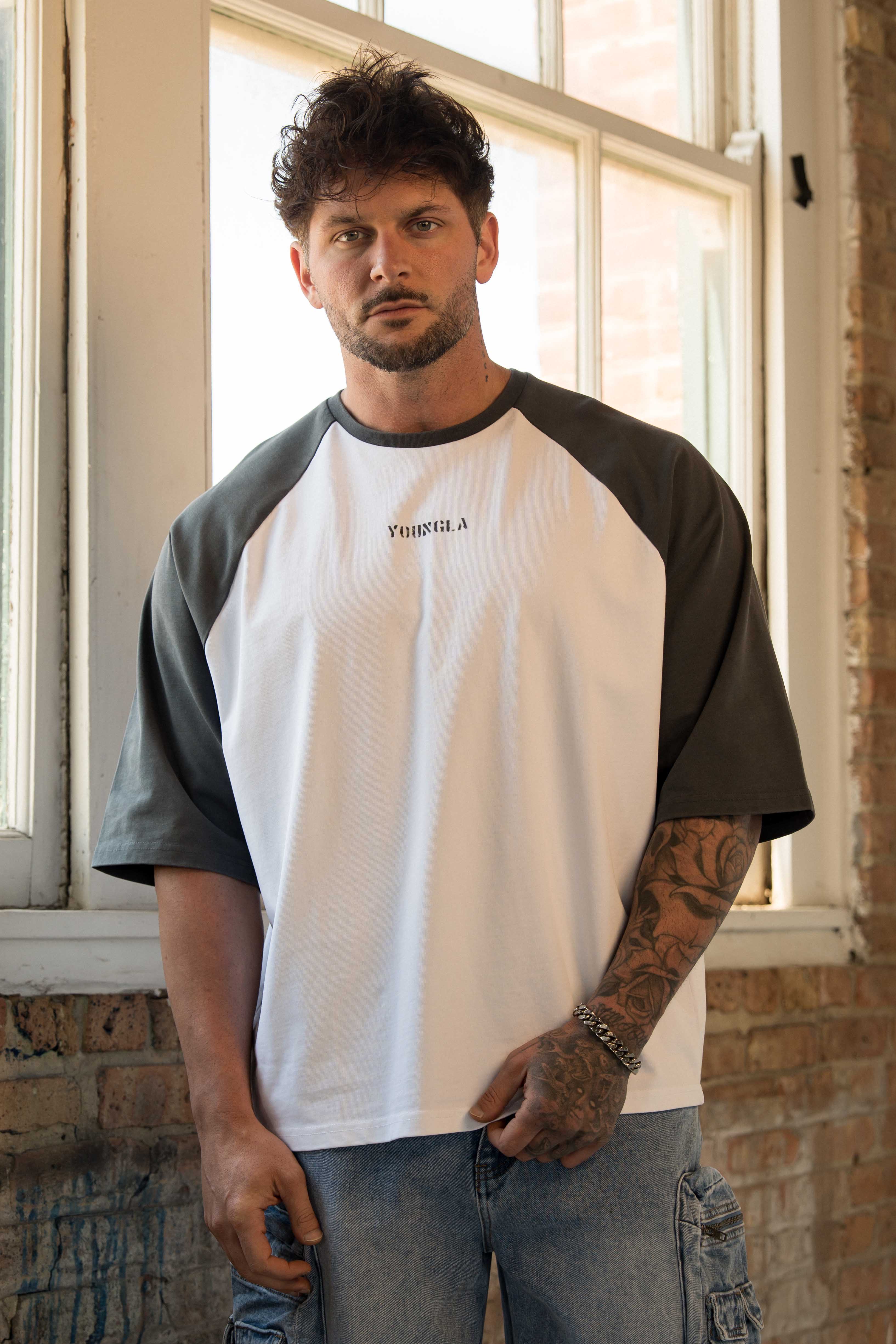 Side view showcasing the contrasting raglan sleeves of the oversized t shirt.
