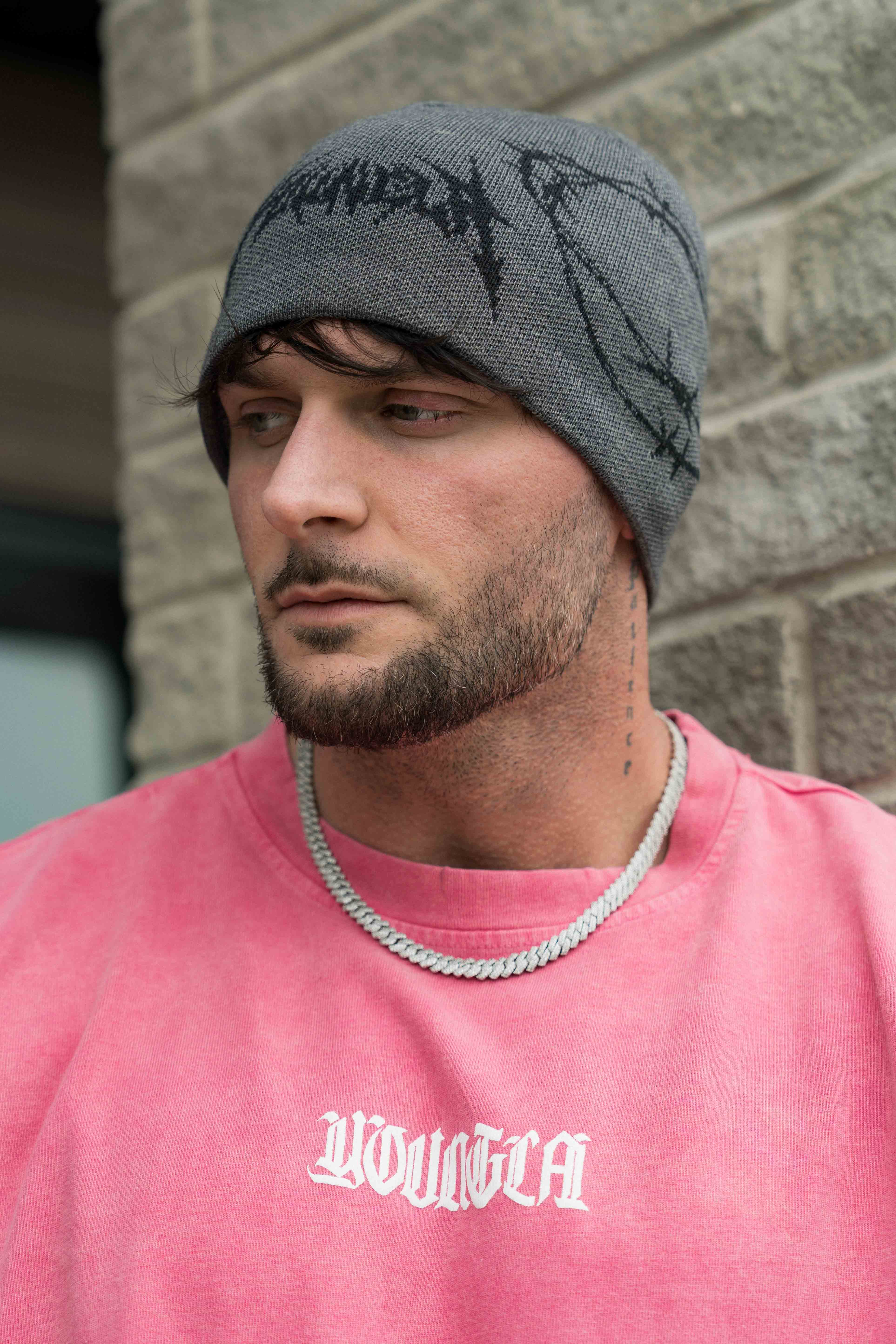 Front view of the wool blend beanie with barbed wire crochet pattern on city streets
