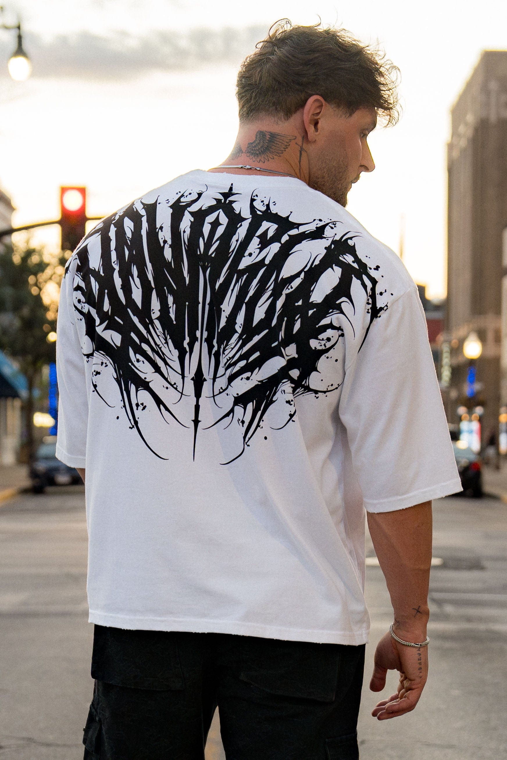 Close-up of the distressed collar and sleeve details on the Chaos tee.