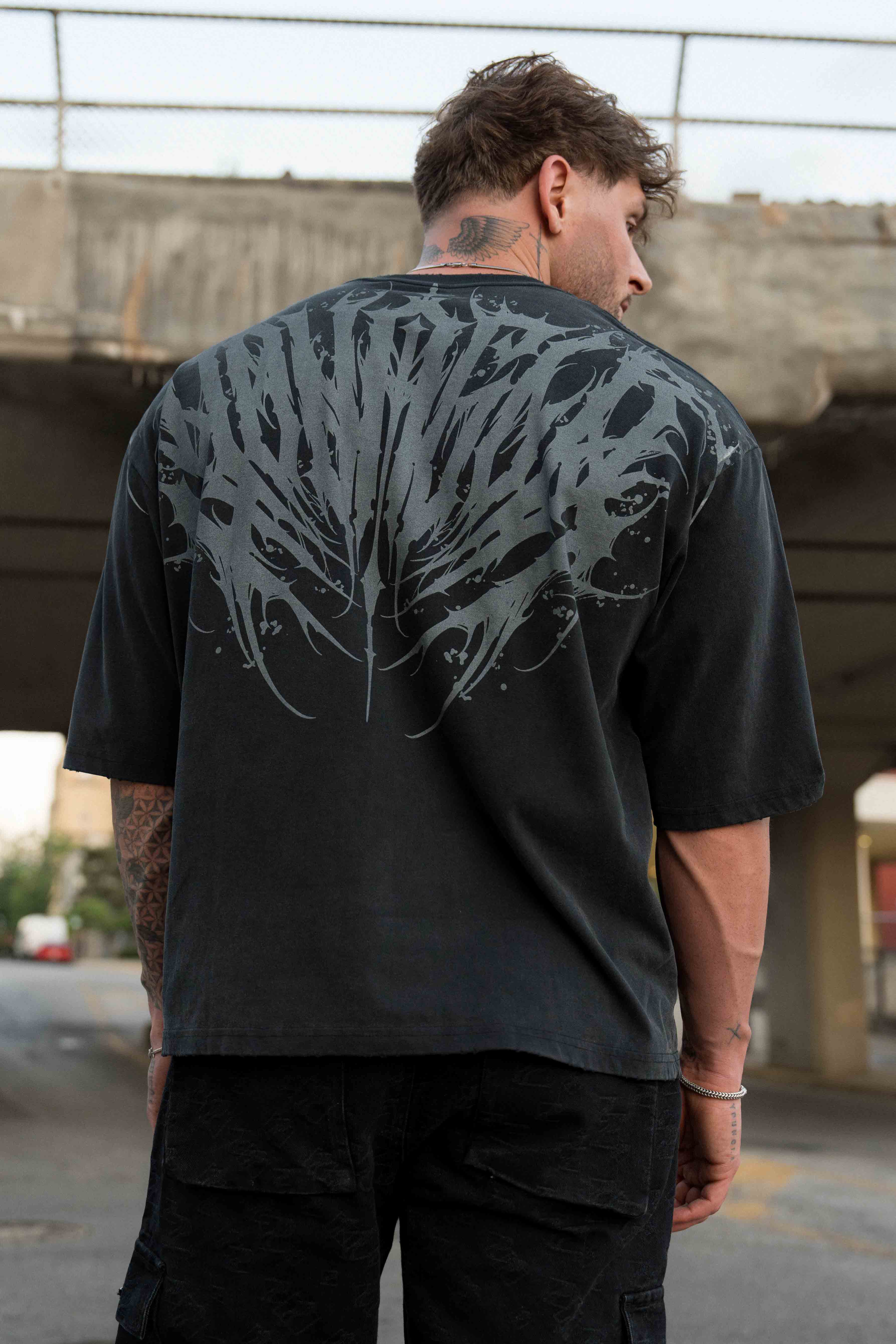 Front view of Chaos oversized graphic tee showcasing tattoo-inspired design.