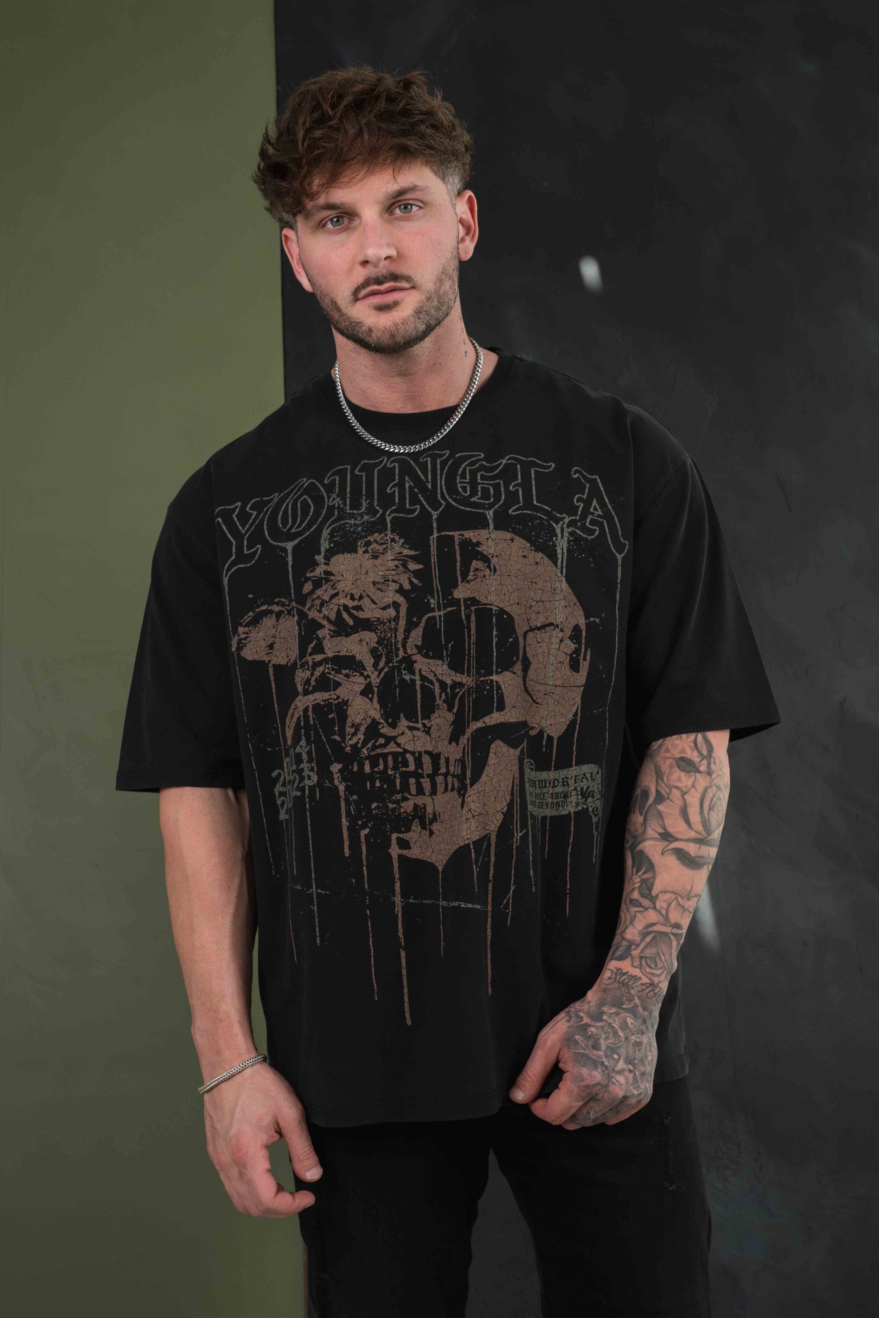 Model wearing a floral skull shirt, highlighting its loose fit.