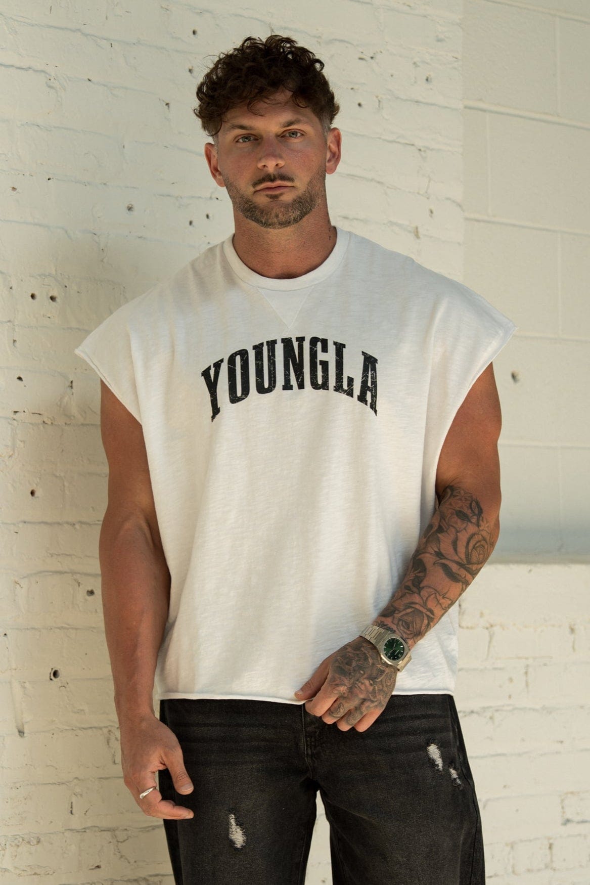 Front view of oversized t-shirt in gym setting, bold logo showing