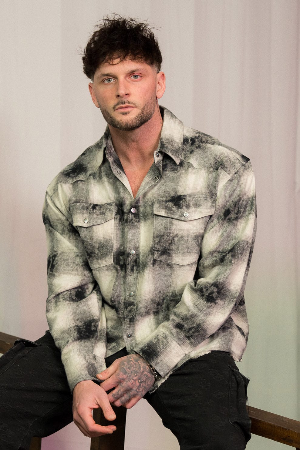 Model wearing the Urban Outlaw flannel shirt, styled for a casual outdoor look.