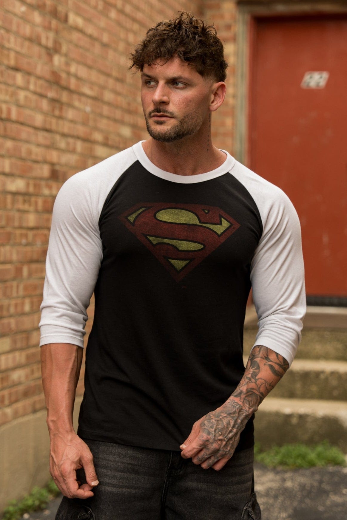 Close-up of the vintage Superman logo on the raglan t-shirt.
