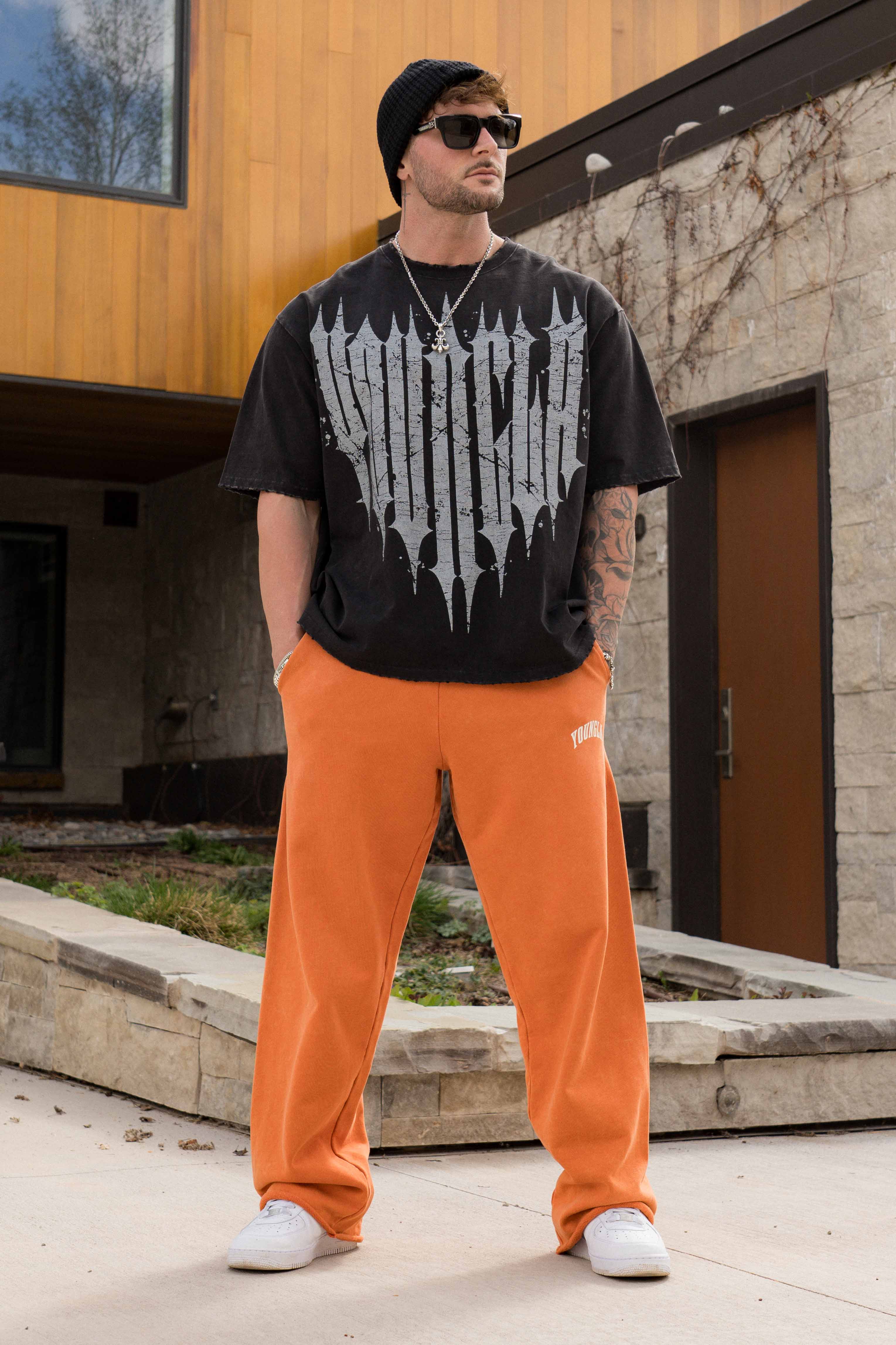 Side view of baggy sweat pants, highlighting the unique pigment-washed fabric.