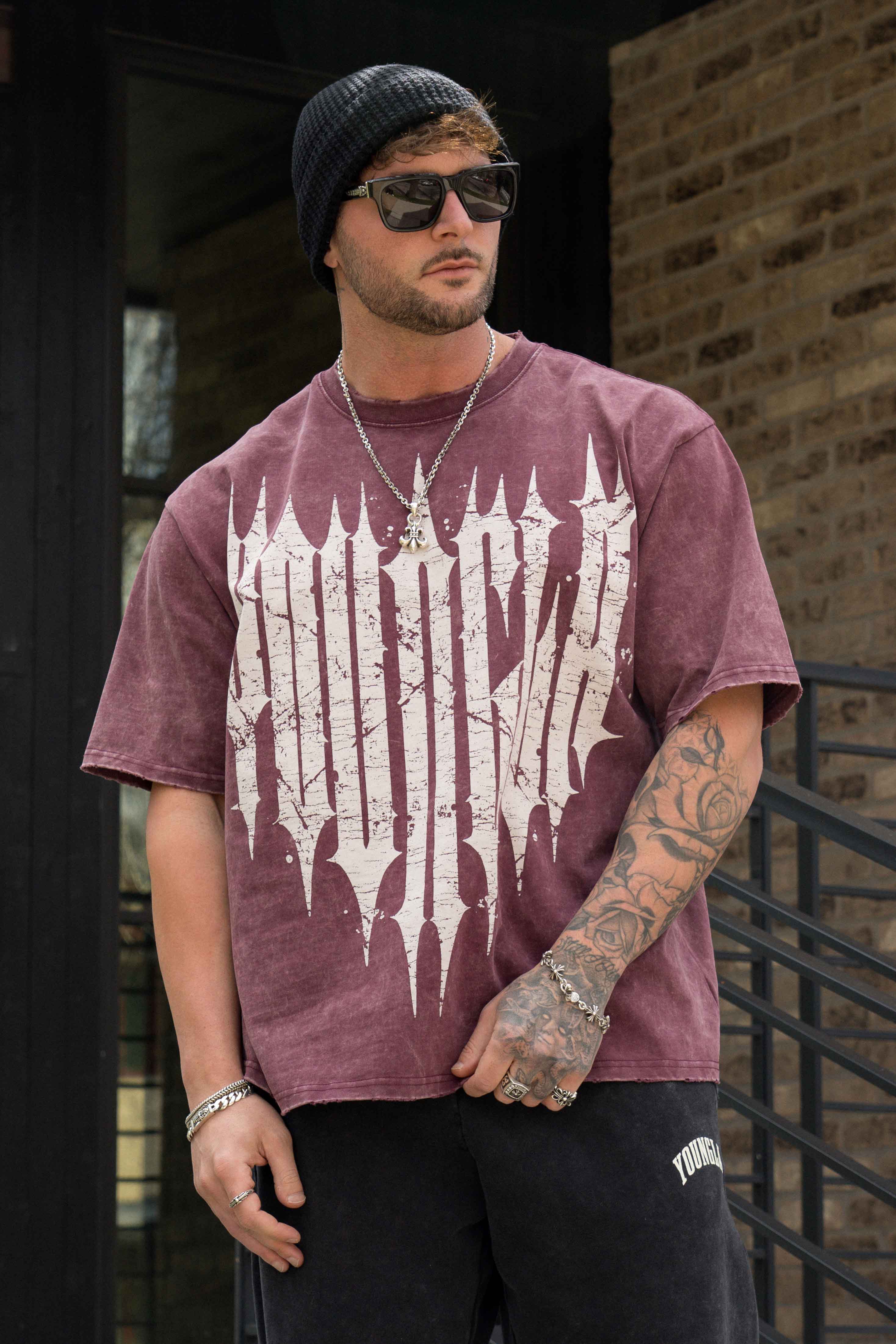 Front view of oversized graphic tee with distressed logo for streetwear clothing