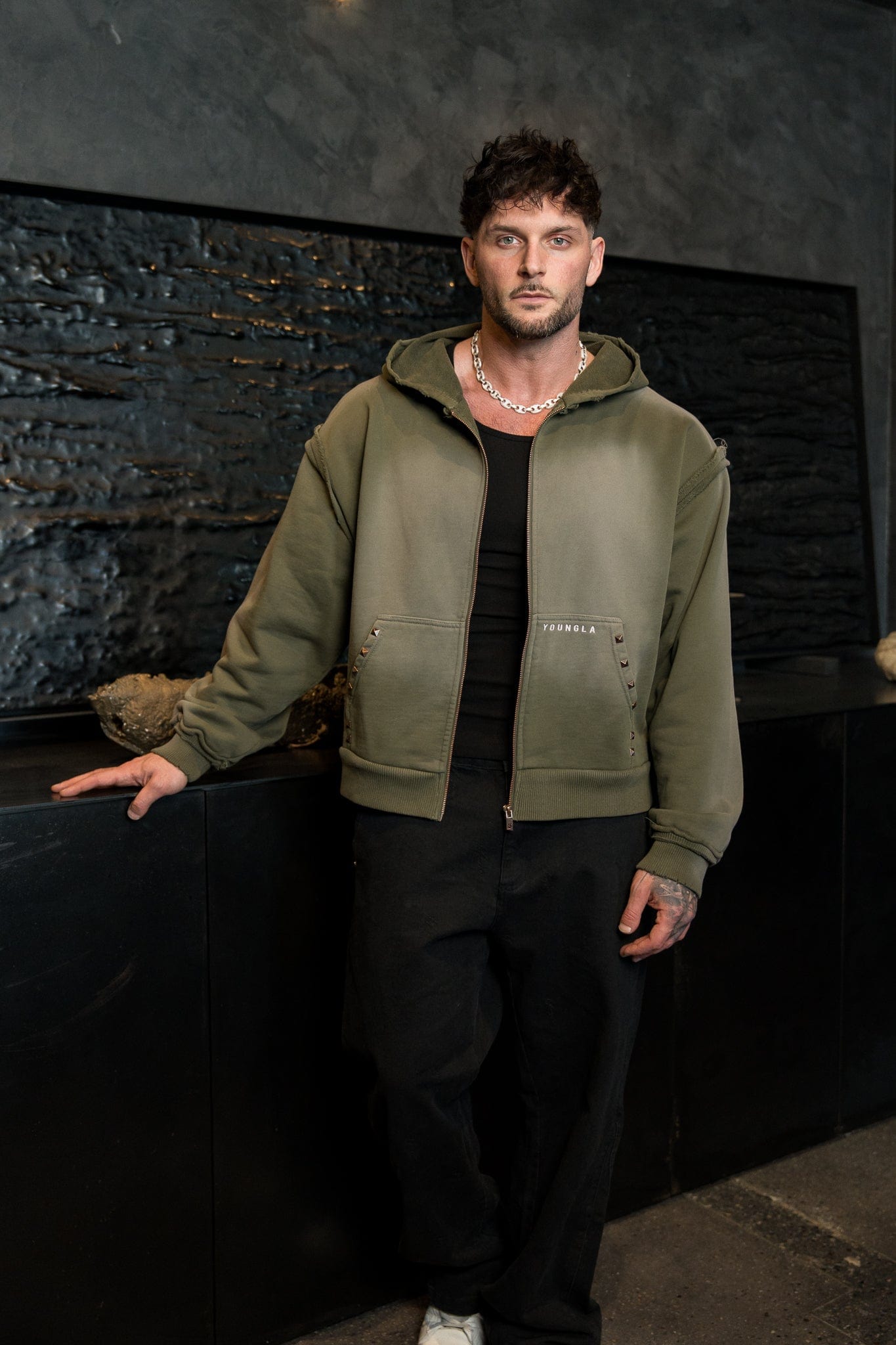 Model showcasing the boxy fit and short length of the deconstructed terry hoodie