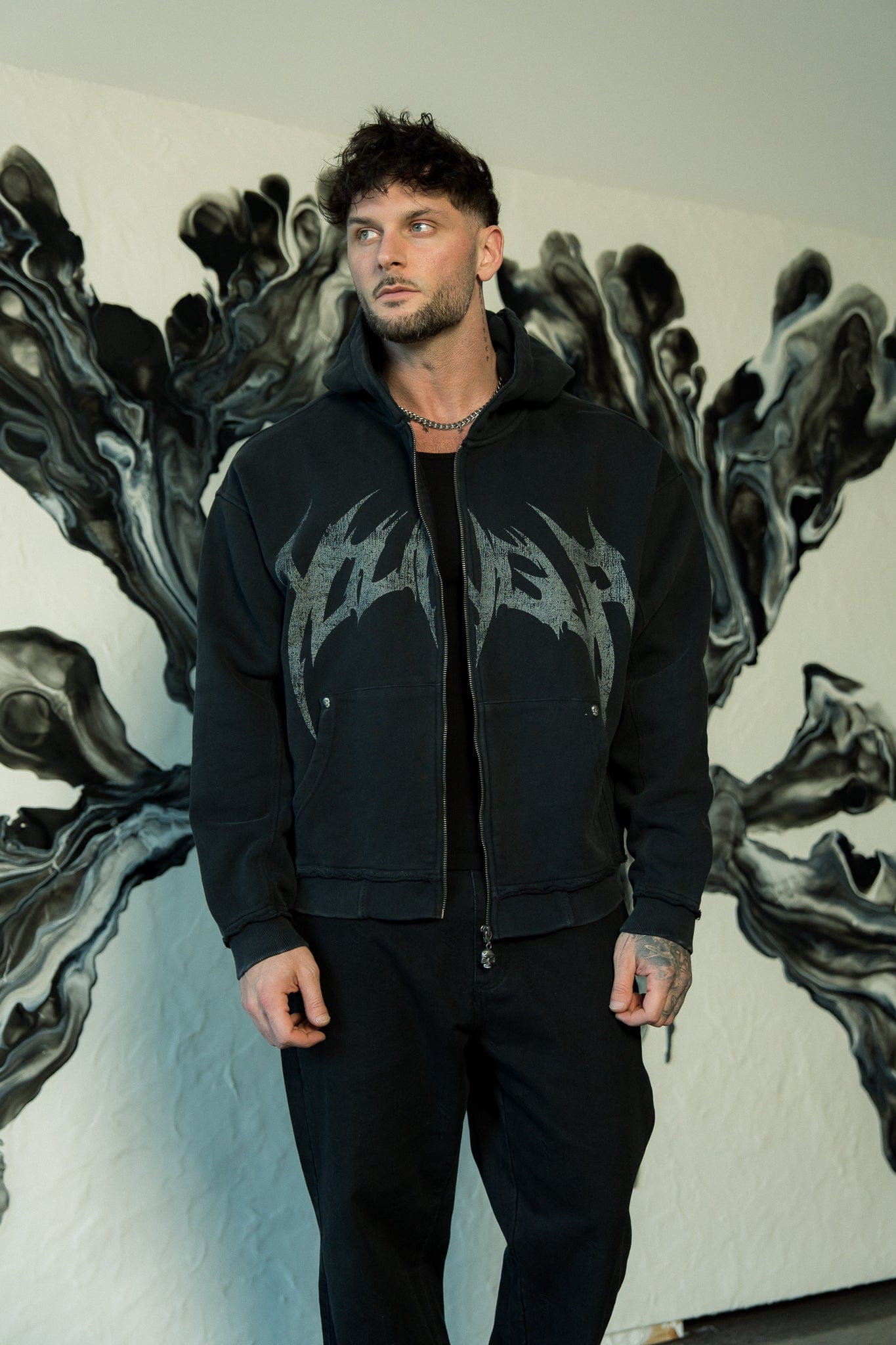 Model wearing the Rebel Spirit hoodie in an urban setting.