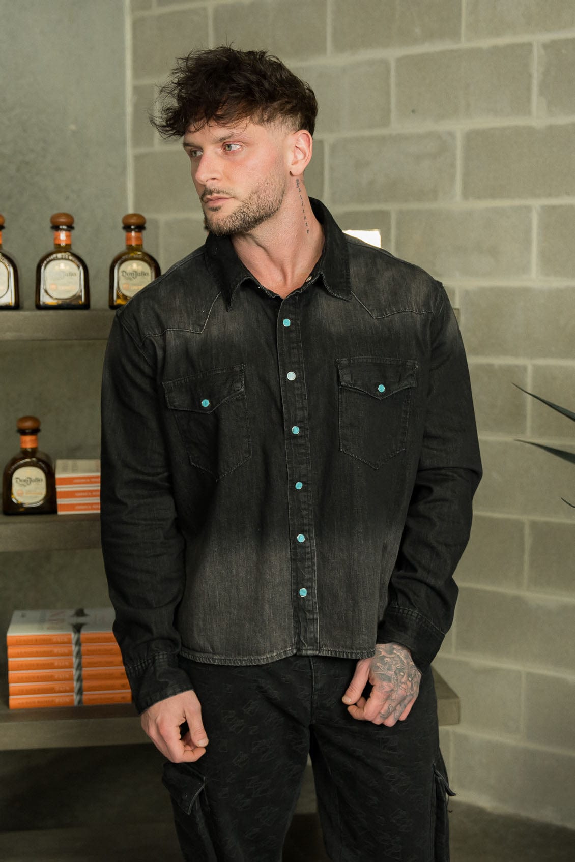 Close-up of the turquoise buttons on the denim shirt.